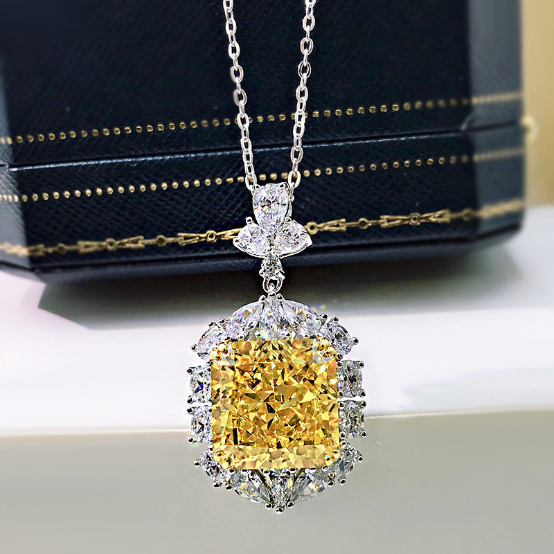 A stunning cushion cut fancy yellow citrine necklace set in 925 sterling silver with white gold accents, featuring brilliant white sapphires.