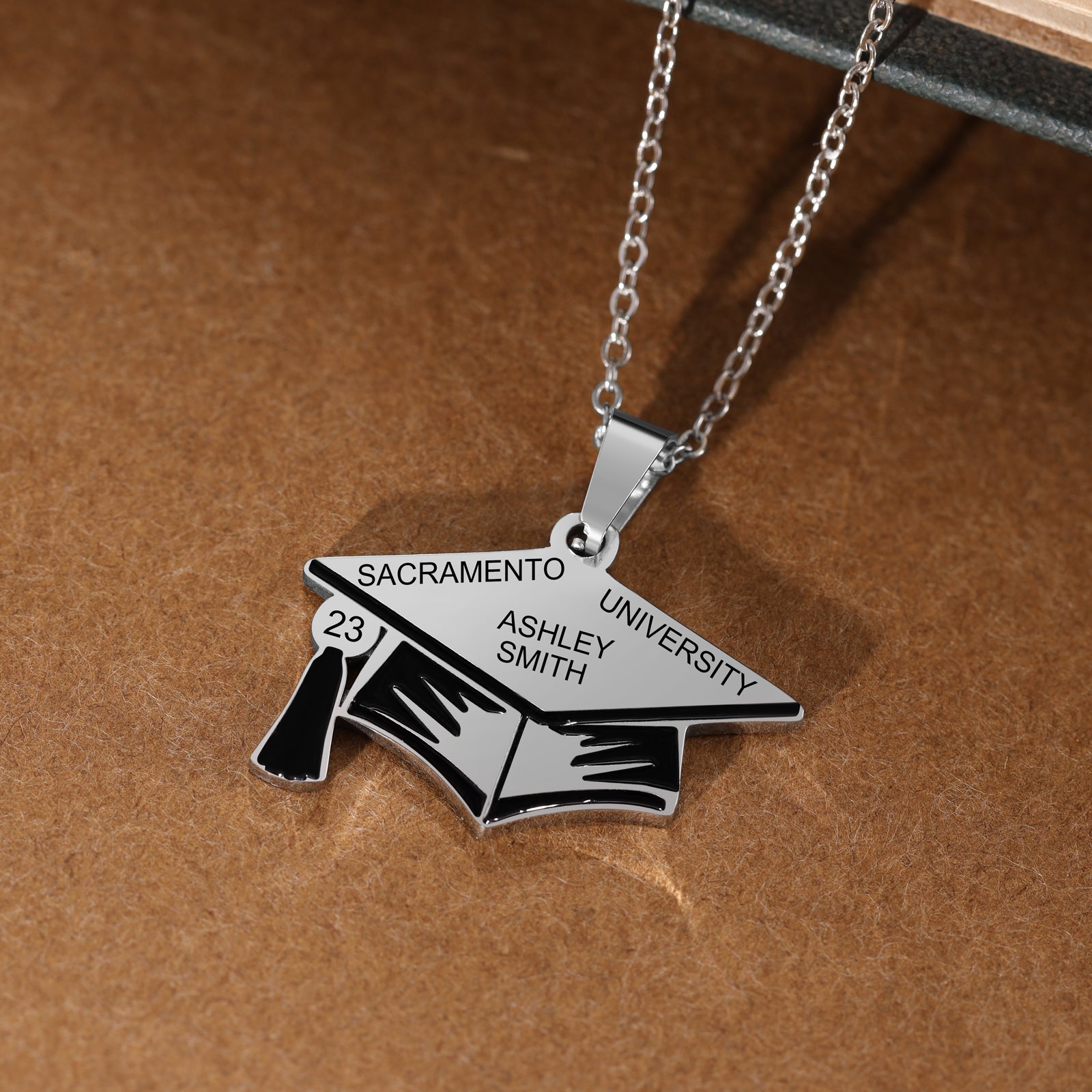 Custom Graduation Hat Necklace made of stainless steel, featuring a graduation cap charm, adjustable length, and tarnish-resistant finish.