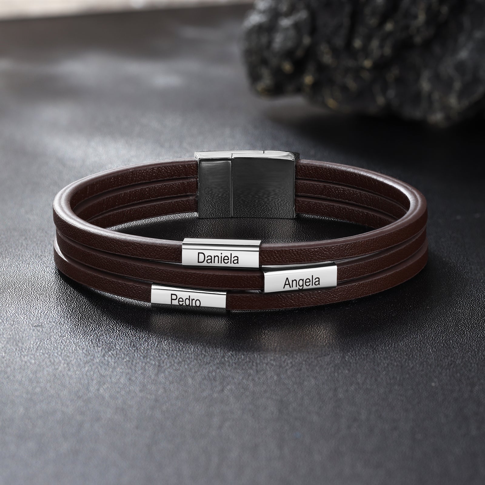 Custom Name Leather Bracelet in black with stainless steel accents, showcasing personalized name engraving.