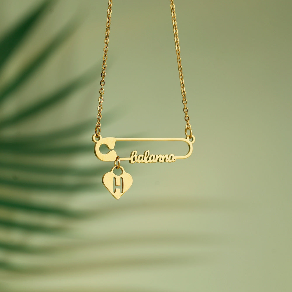 Custom Name Safety Pin Initial Necklace made of stainless steel, featuring a unique safety pin design, tarnish-resistant and hypoallergenic.