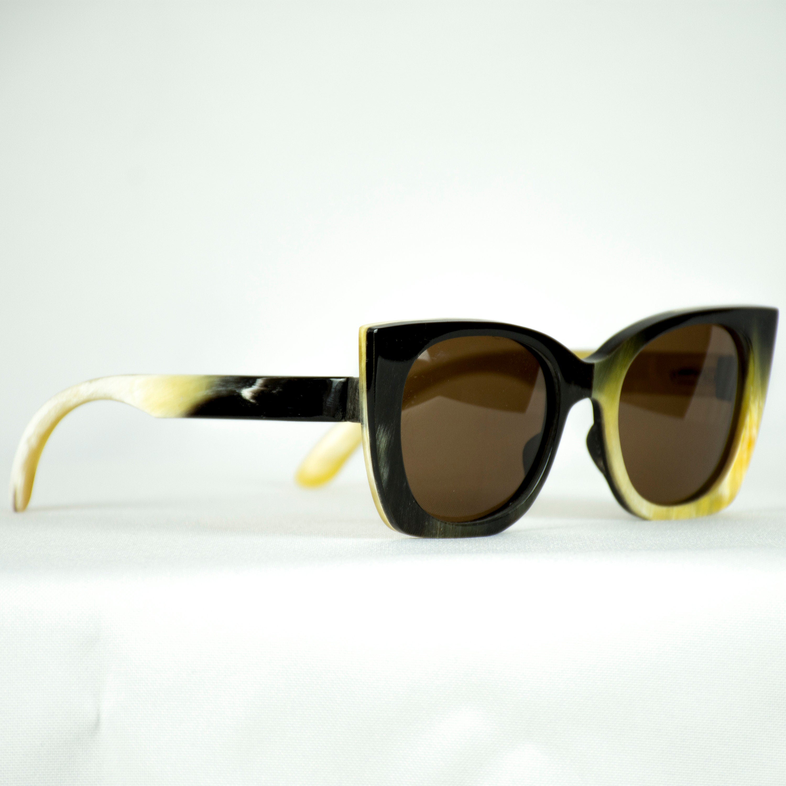 Custom sunglasses made from real natural cow horn with brown lenses, showcasing unique patterns and a stylish design.