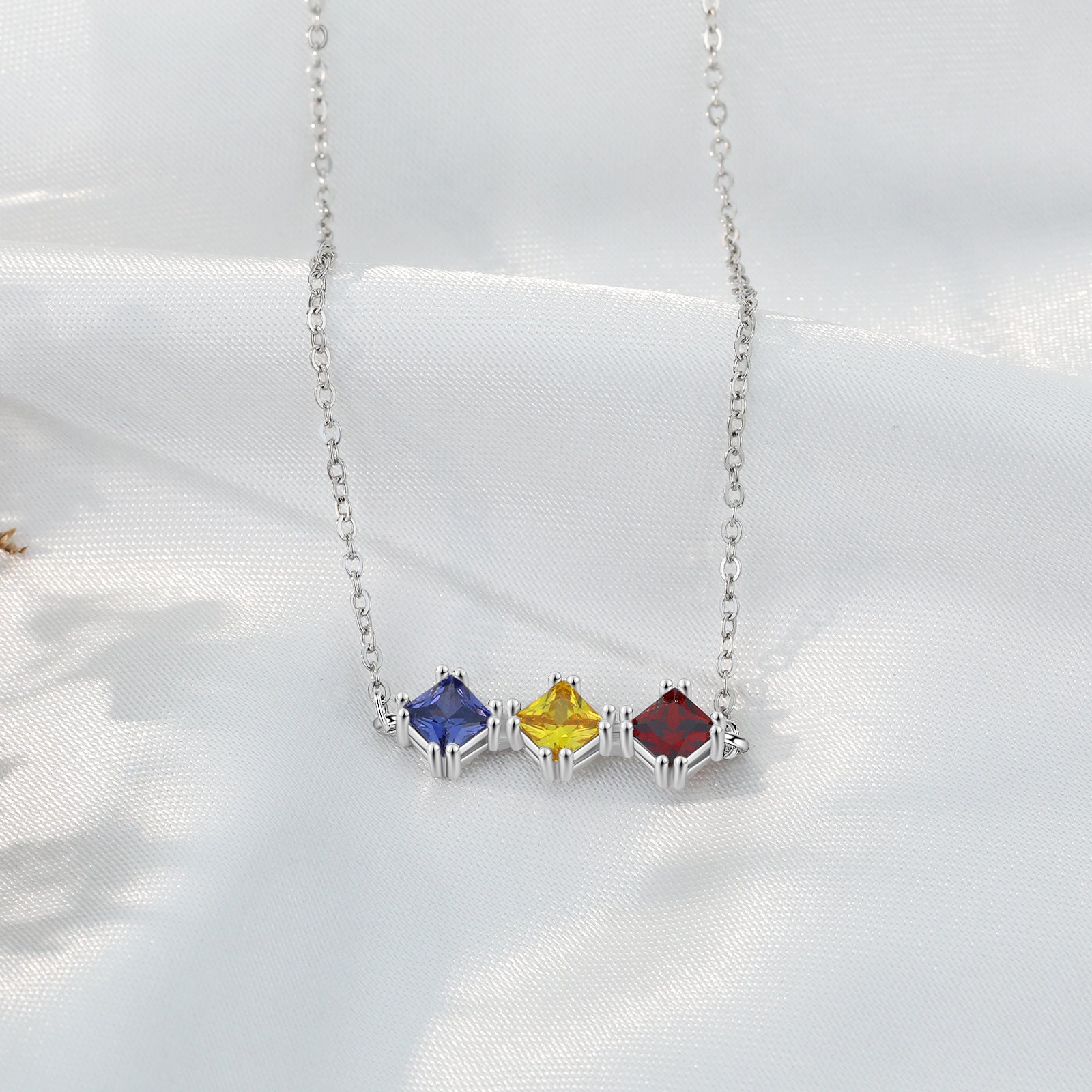 Custom Three Birthstone Necklace in white gold plating with three personalized birthstones.