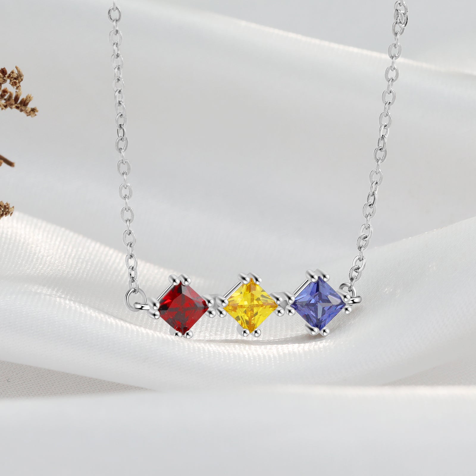 Custom Three Birthstone Necklace in white gold plating with three personalized birthstones.