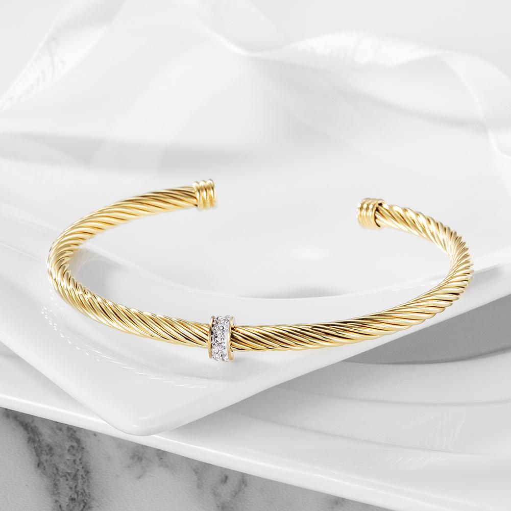 CZ Cable Cuff made of 316L surgical stainless steel with 14K gold PVD plating, showcasing its elegant design.