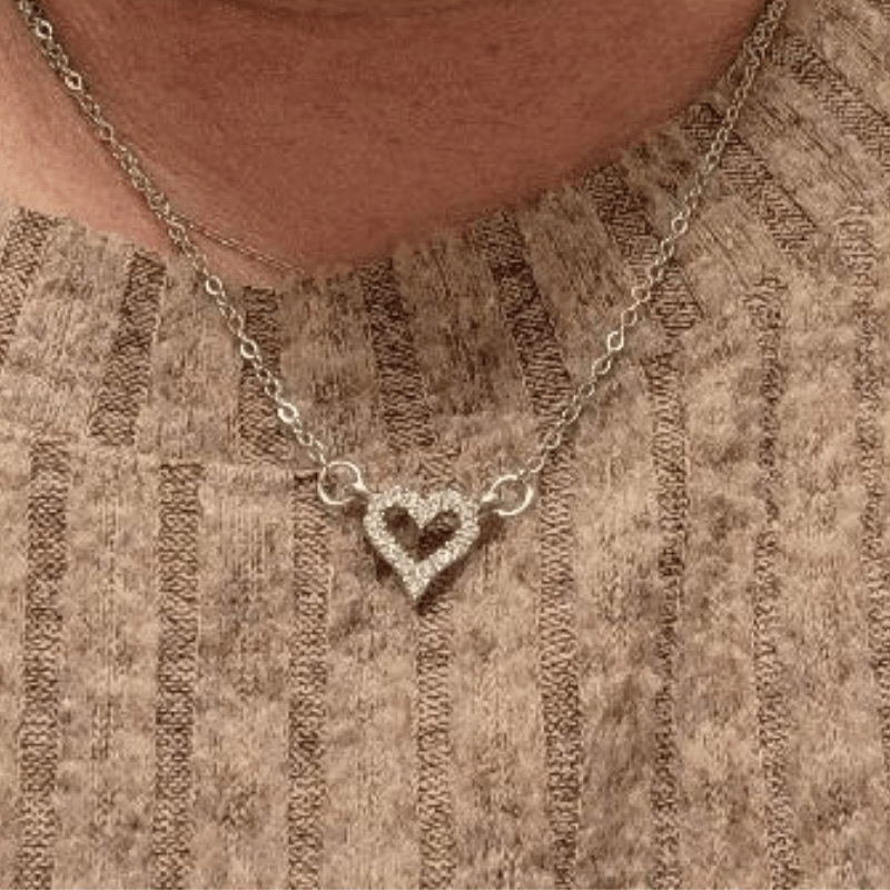 CZ Heart Necklace featuring a hollow heart pendant on an 18-inch silver clavical chain, elegantly crafted from stainless steel.