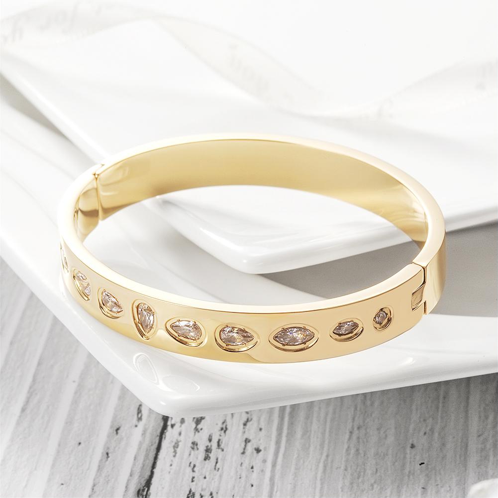 CZ Station Hinge Bangle made of surgical stainless steel with gold plating and cubic zirconia accents.