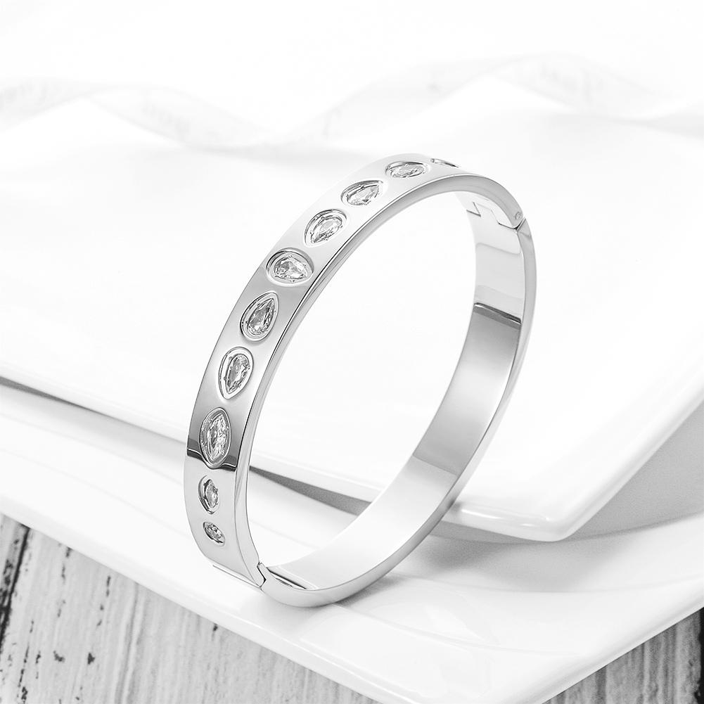 CZ Station Hinge Bangle made of surgical stainless steel with gold plating and cubic zirconia accents.