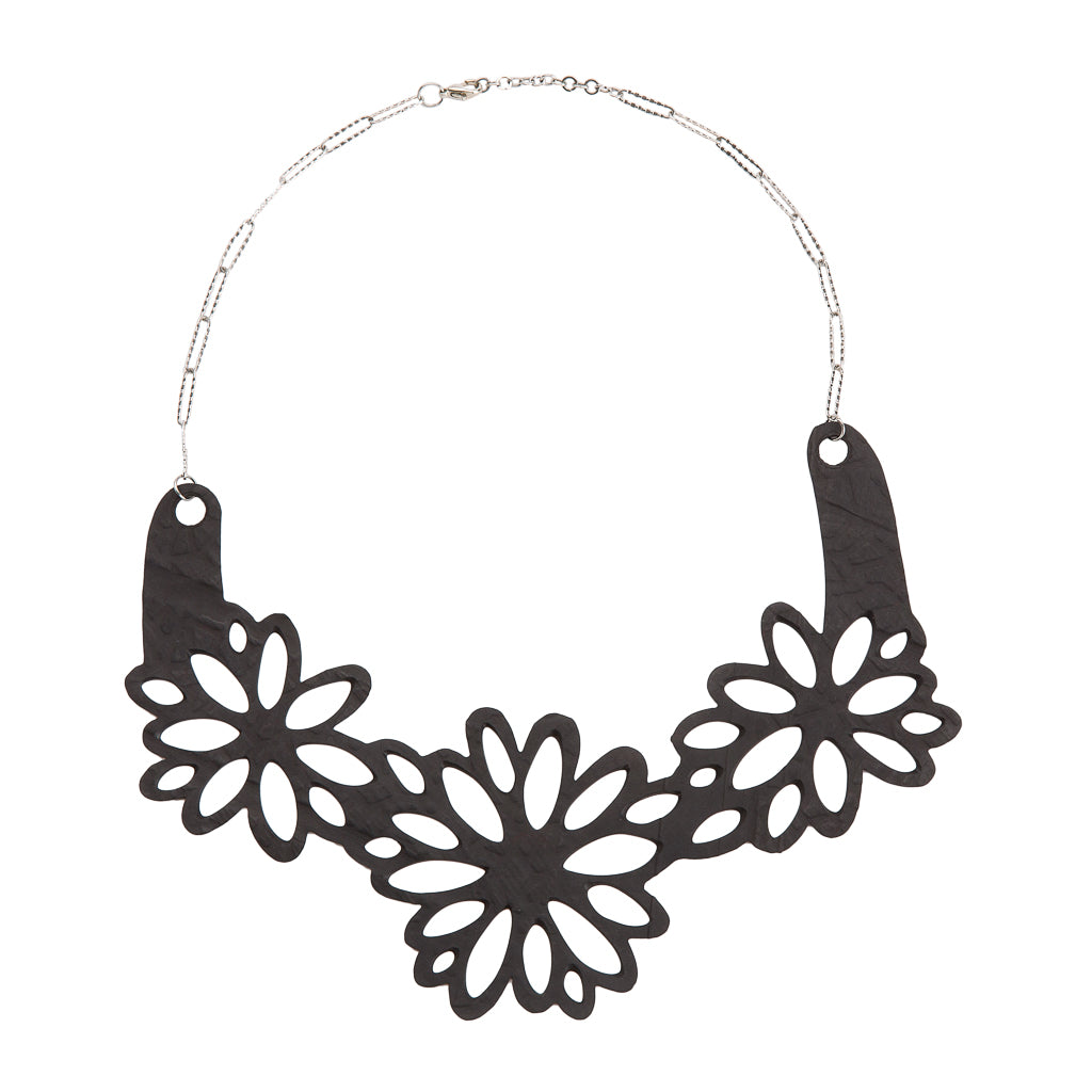 Dahlia Inner Tube Floral Necklace featuring handcut flowers from reclaimed rubber, displayed elegantly on a soft background.