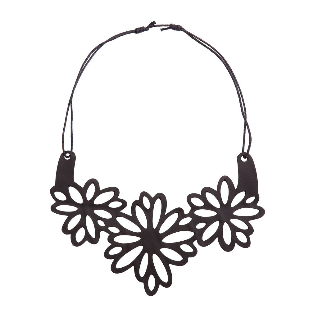 Dahlia Inner Tube Floral Necklace featuring handcut flowers from reclaimed rubber, displayed elegantly on a soft background.