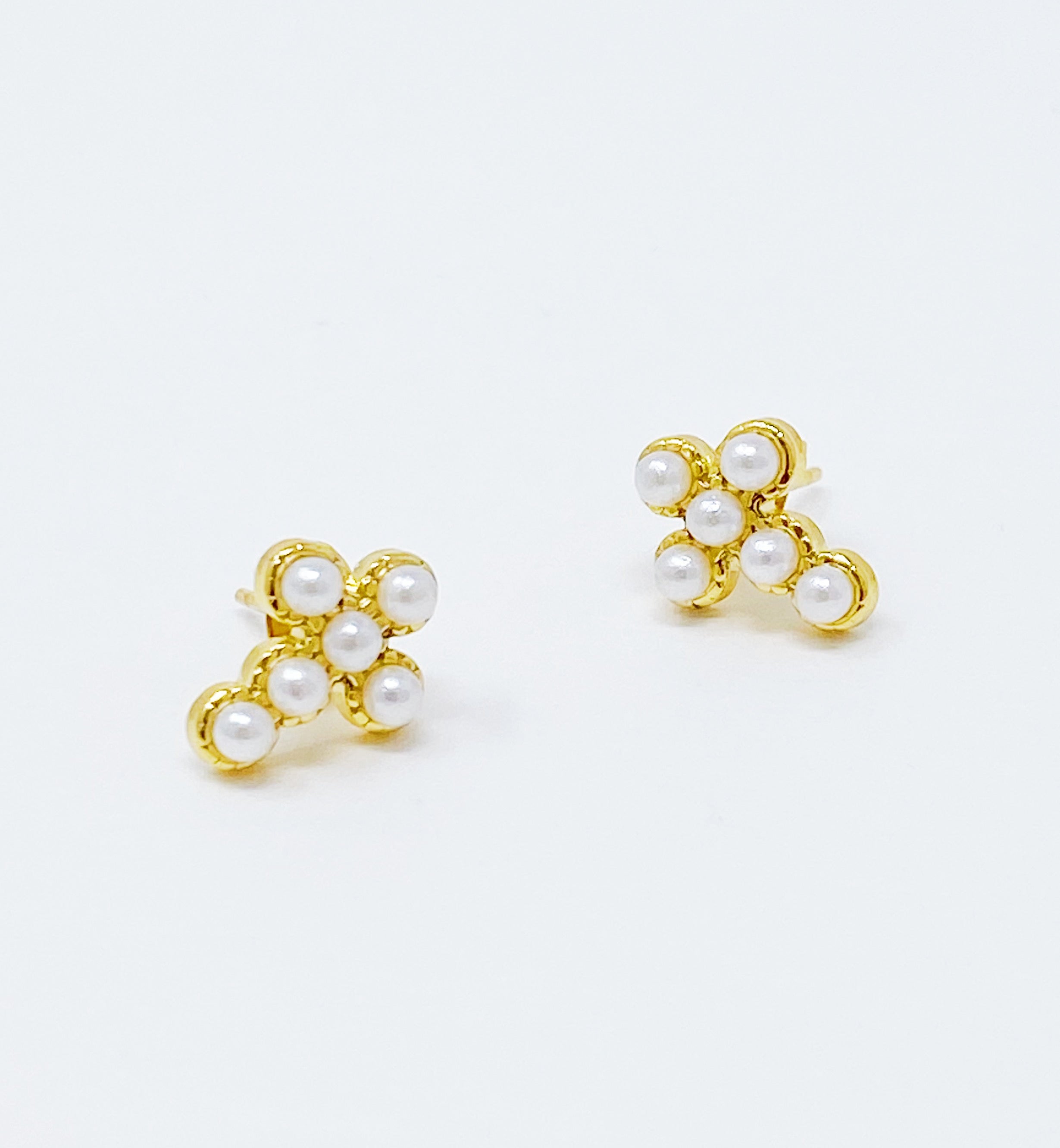 Dainty Cross Stud Earrings featuring sparkly cubic zirconia and pearl beads on a gold plated stainless steel base.