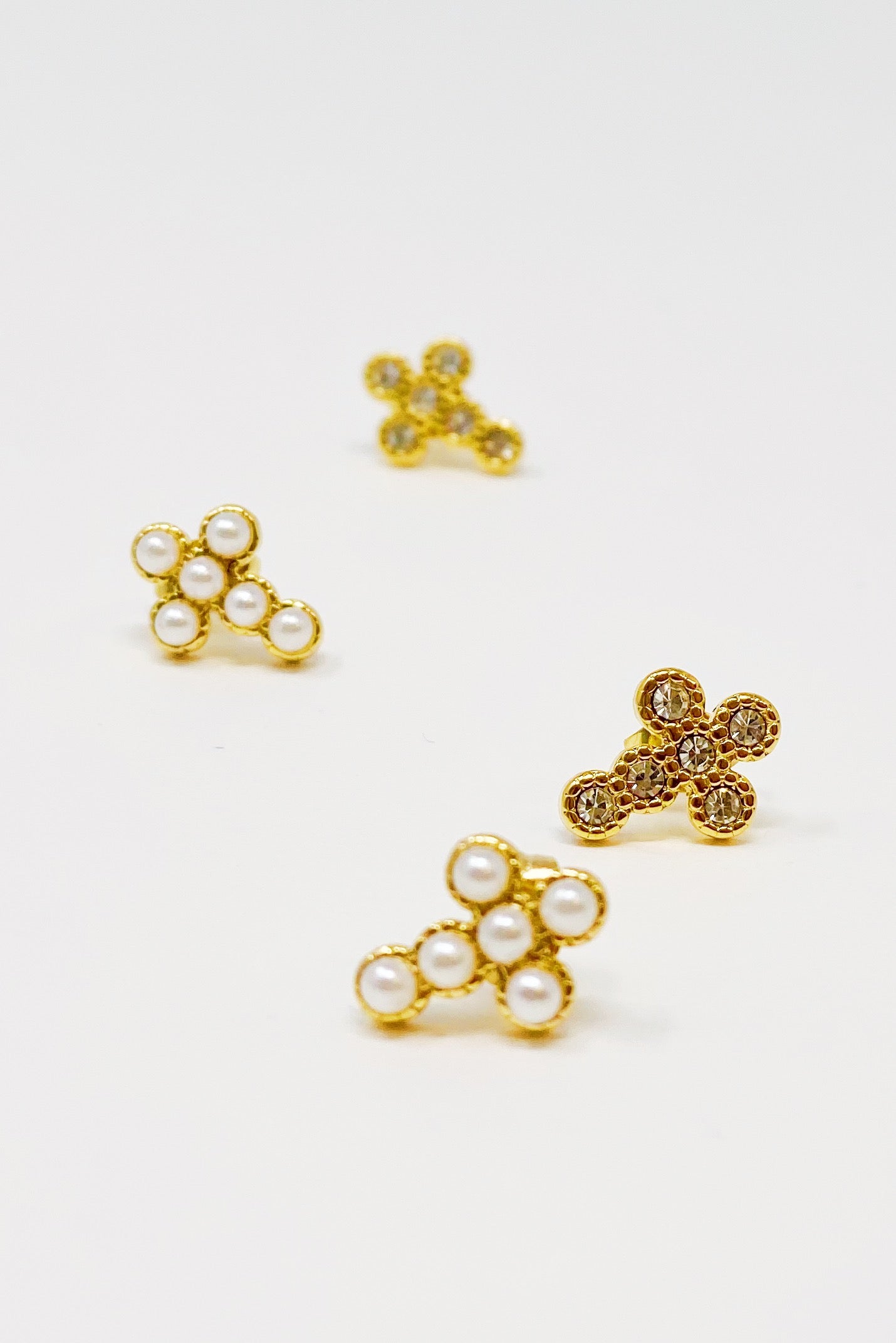 Dainty Cross Stud Earrings featuring sparkly cubic zirconia and pearl beads on a gold plated stainless steel base.