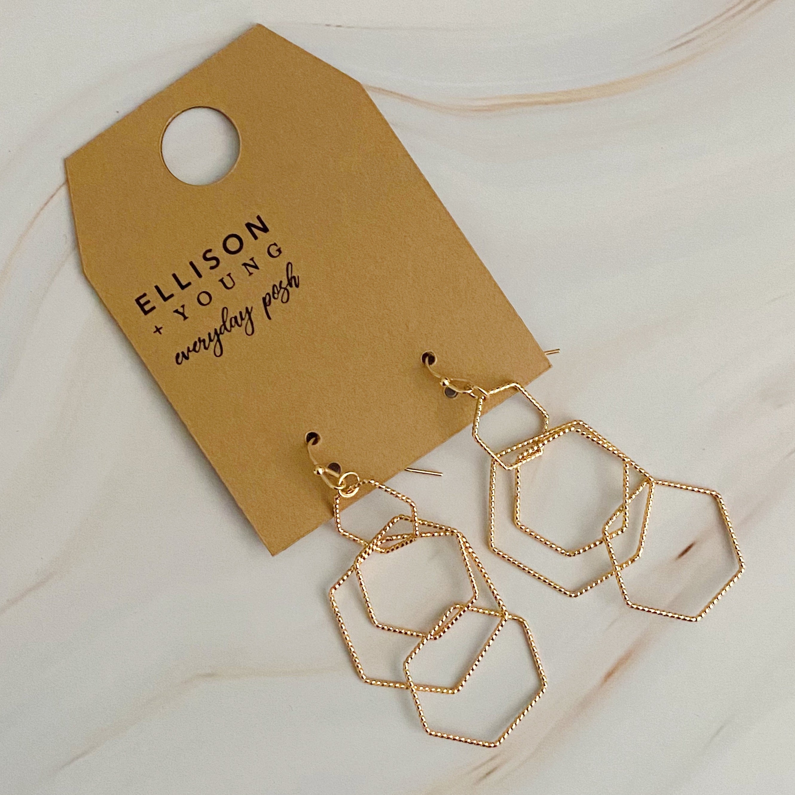 Dainty Dimensional Drop Earrings featuring hexagon designs in gold plated alloy, showcasing a beautiful shine and lightweight construction.