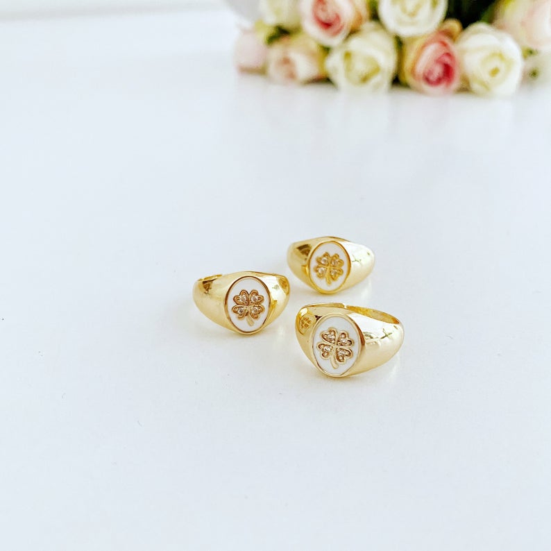 A collection of dainty adjustable evil eye rings in gold, featuring a white evil eye design, perfect for everyday wear.