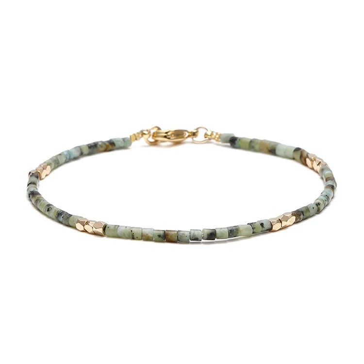 Dainty Gemstone Tube Bead Bracelet featuring tiny natural gemstone beads in various colors, adjustable size for comfort.