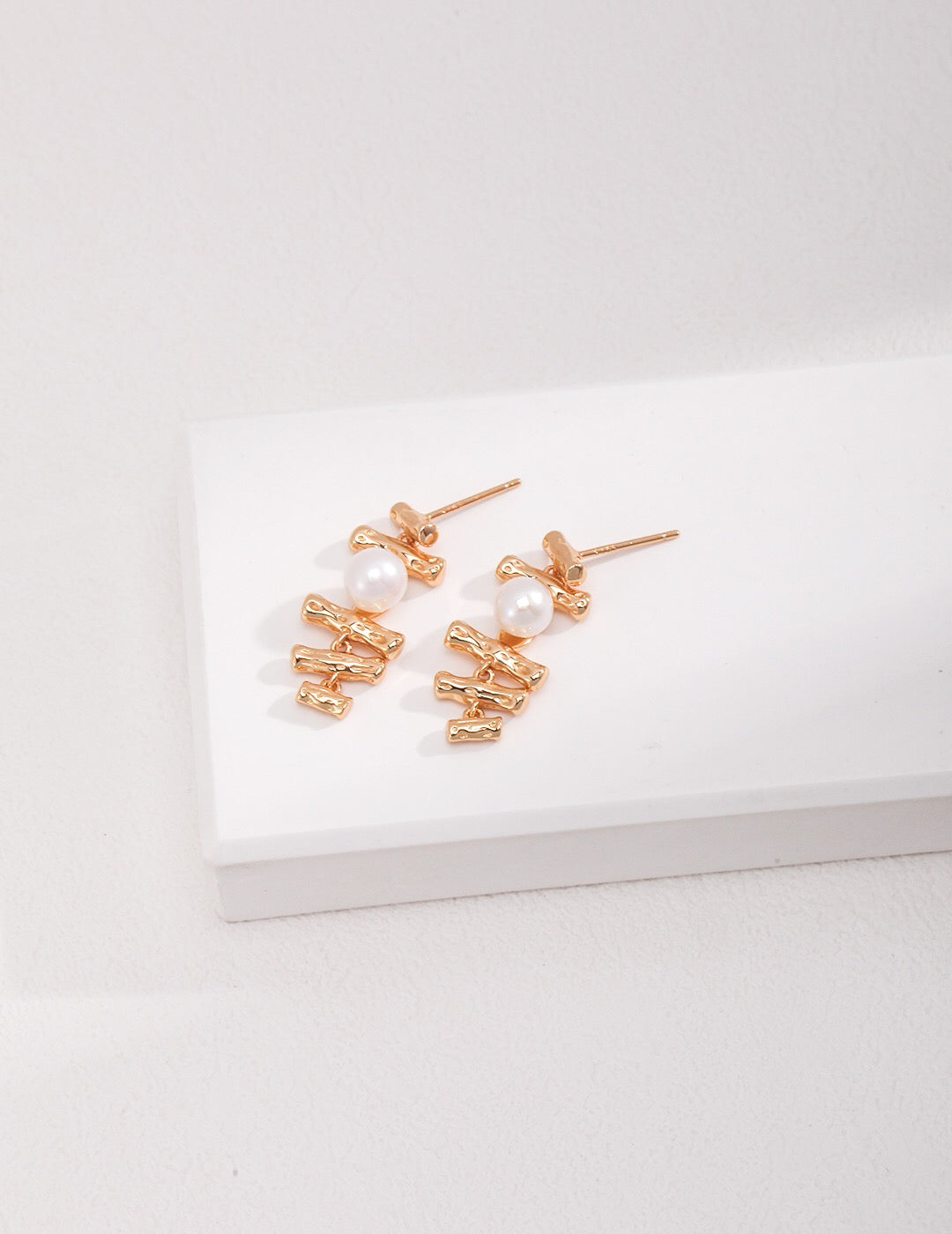 Dainty Geometric Pearl Earrings featuring baroque pearls and sterling silver with gold vermeil plating, elegantly displayed.