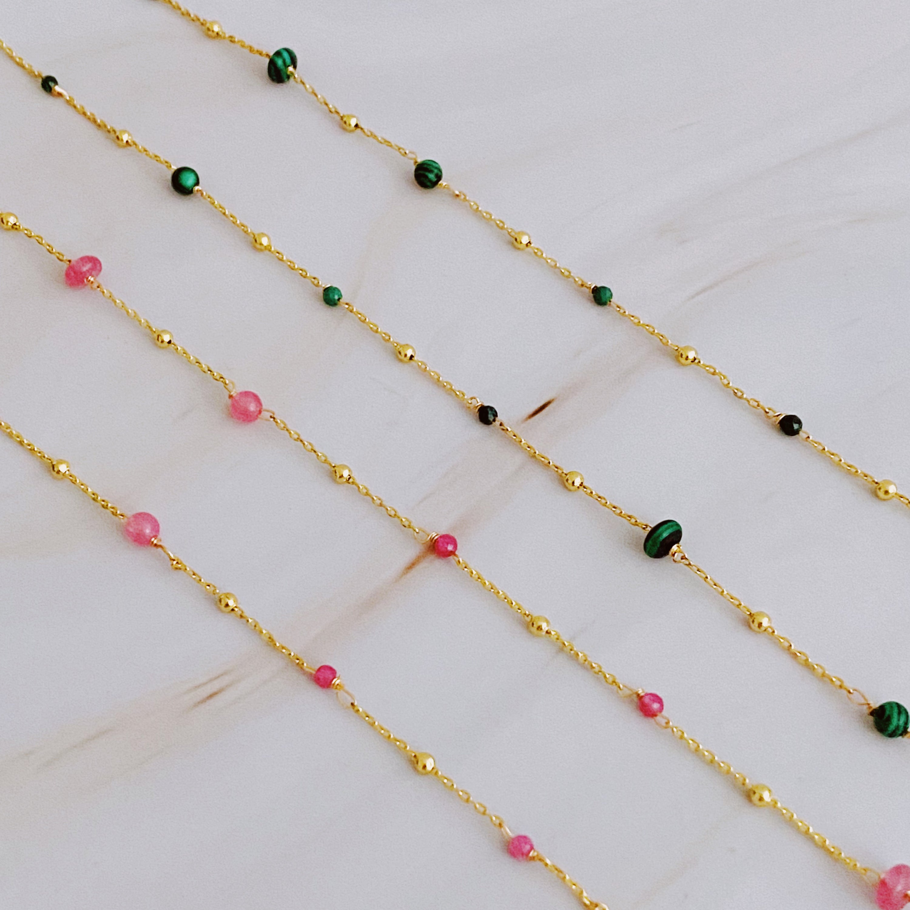 A delicate Dainty Precious Stone Bead Necklace featuring varying sizes of natural stone beads on a gold plated chain.