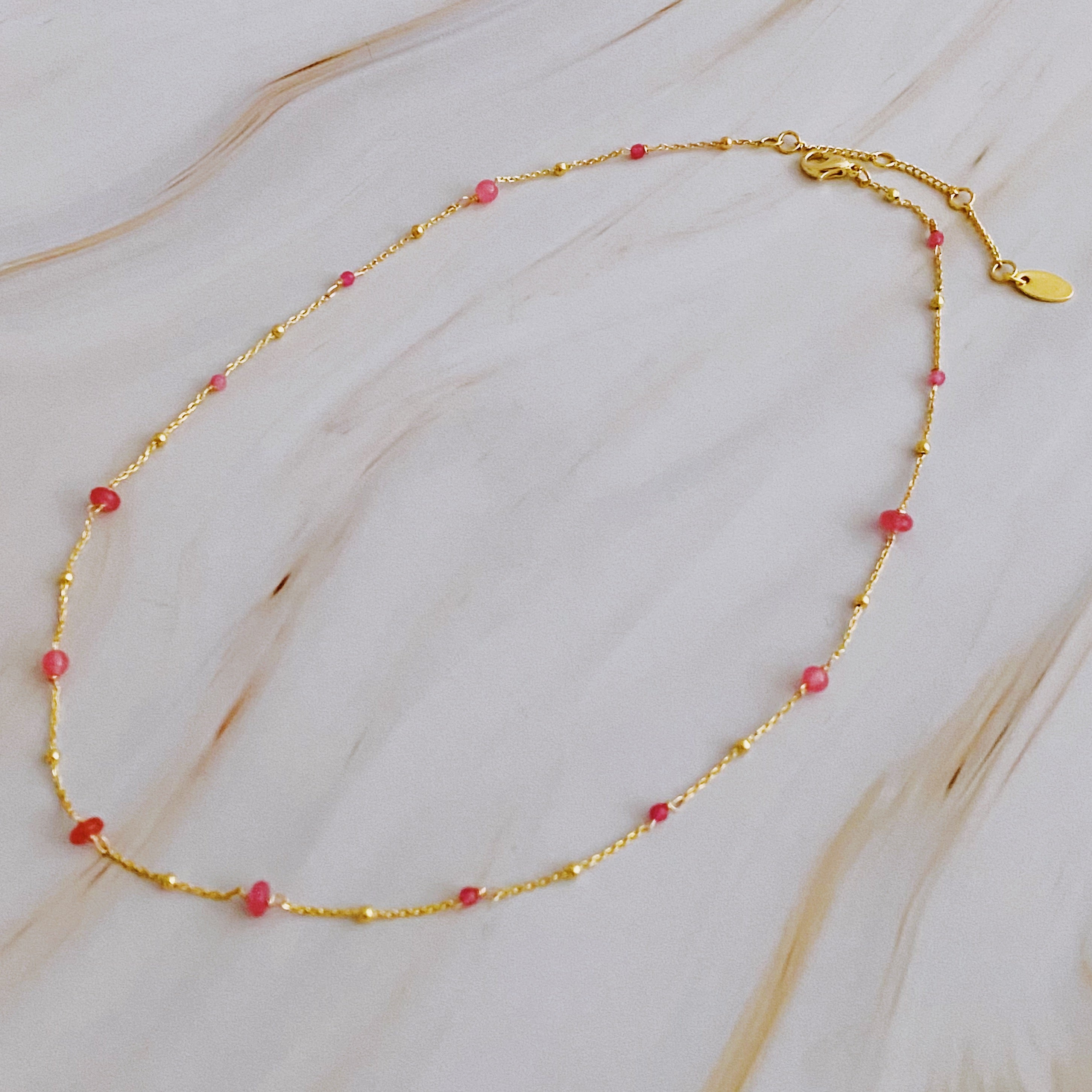 A delicate Dainty Precious Stone Bead Necklace featuring varying sizes of natural stone beads on a gold plated chain.