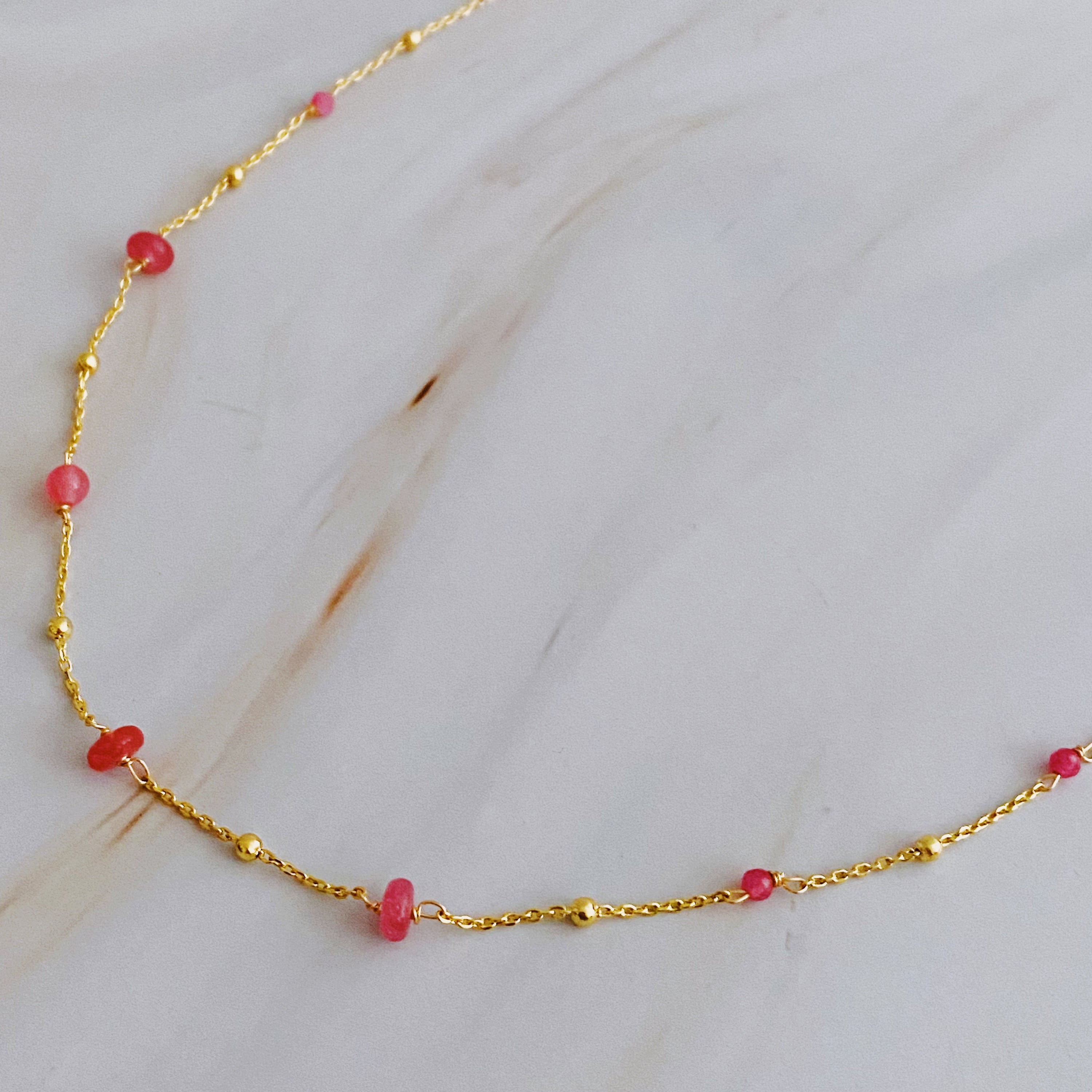 A delicate Dainty Precious Stone Bead Necklace featuring varying sizes of natural stone beads on a gold plated chain.