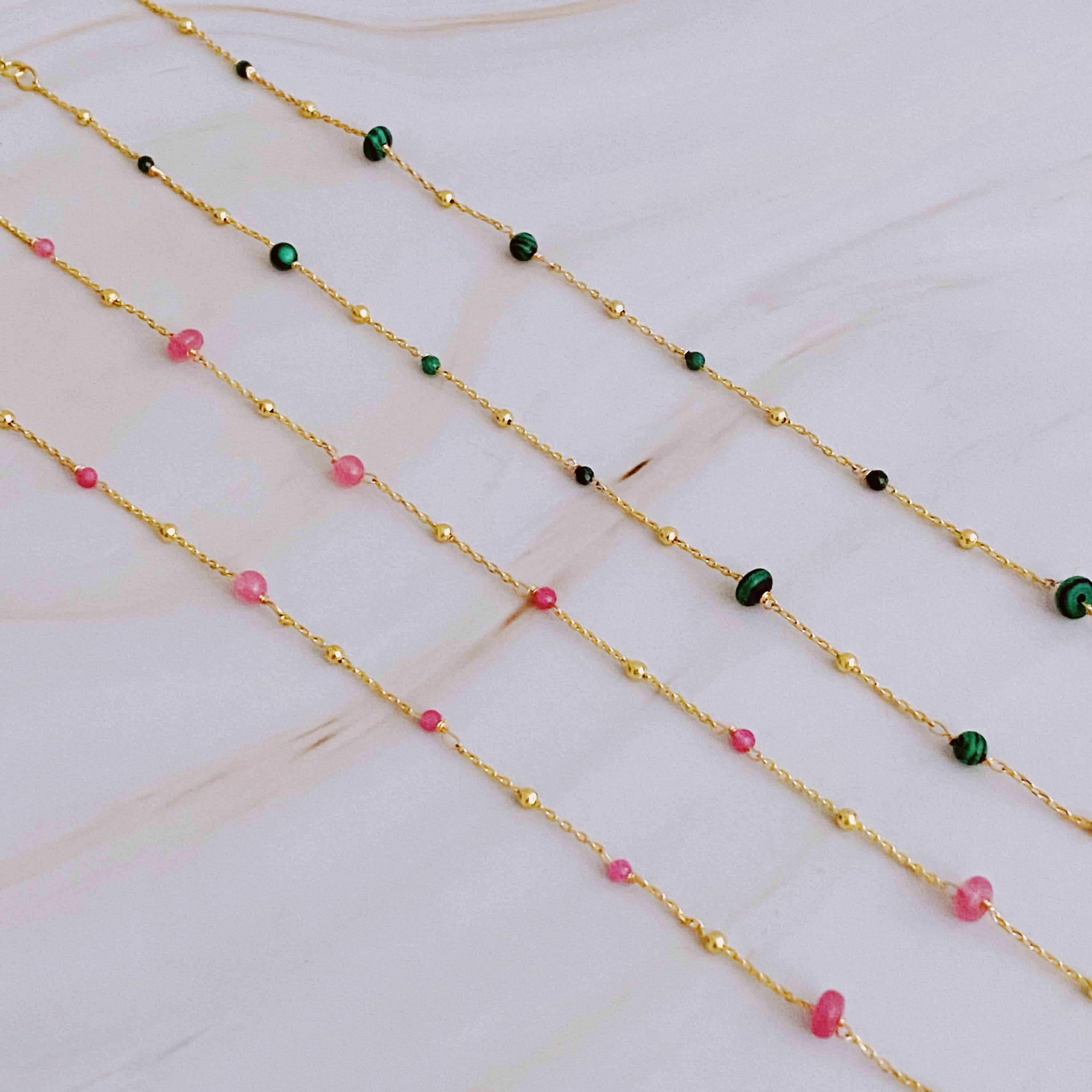 A delicate Dainty Precious Stone Bead Necklace featuring varying sizes of natural stone beads on a gold plated chain.