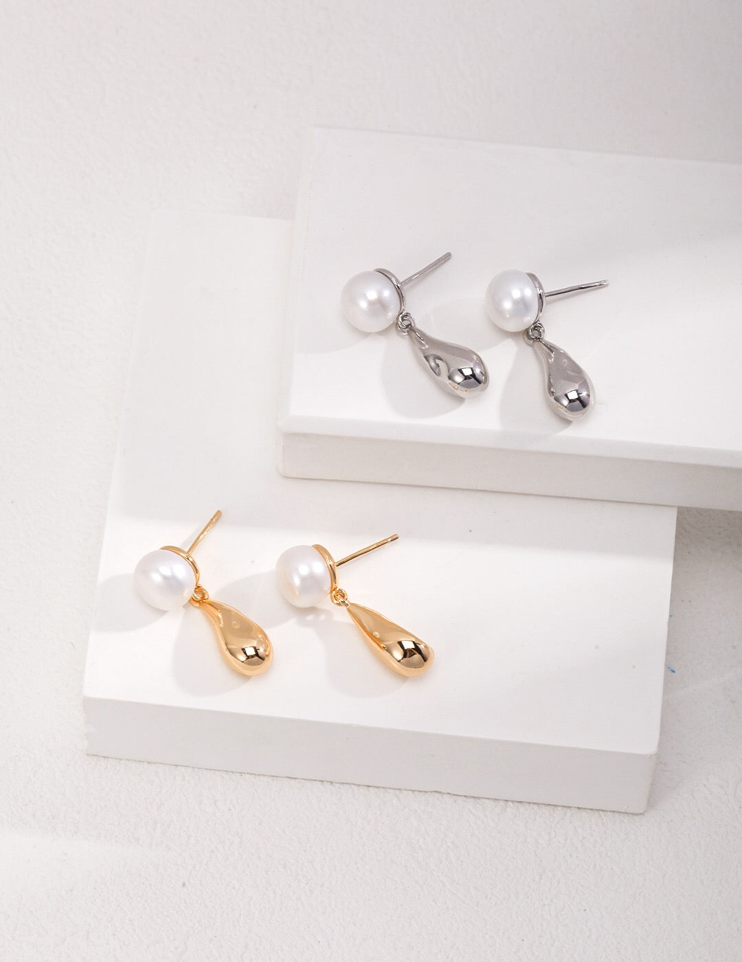 A pair of elegant Dainty Raindrop Earrings featuring natural pearls and gold vermeil, showcasing their delicate design.