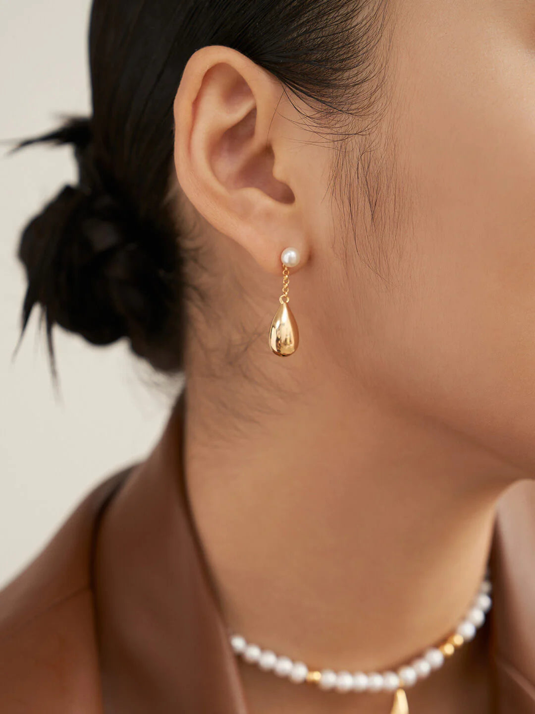 Dainty Raindrop Pearl Earrings featuring natural pearls and gold vermeil, elegantly designed for a sophisticated look.