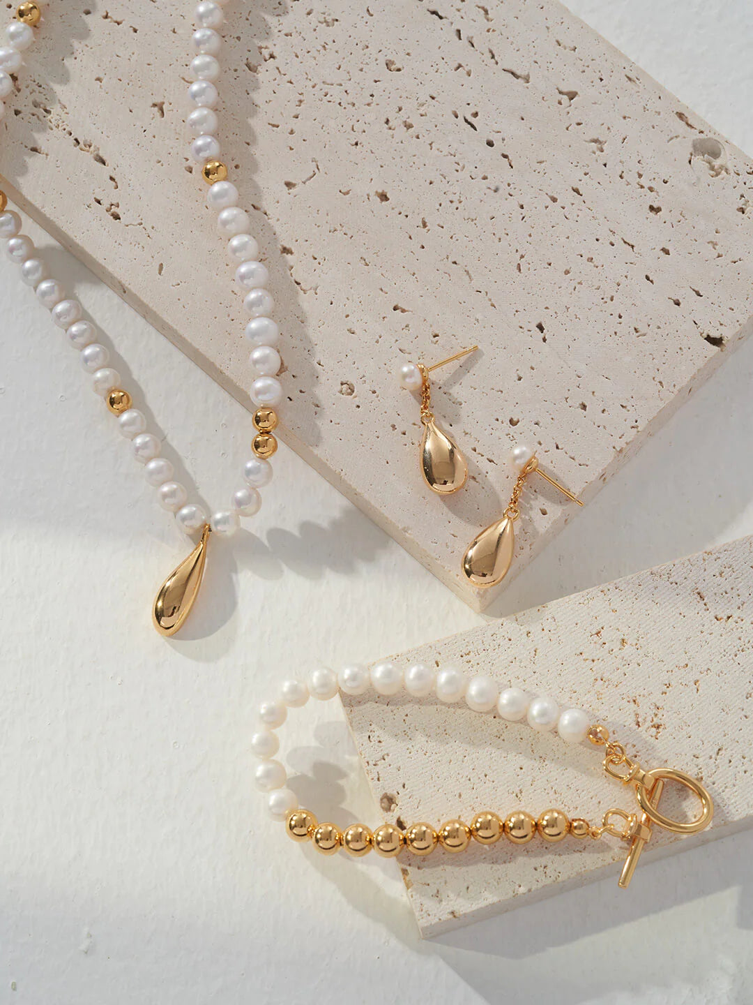 Dainty Raindrop Pearl Earrings featuring natural pearls and gold vermeil, elegantly designed for a sophisticated look.