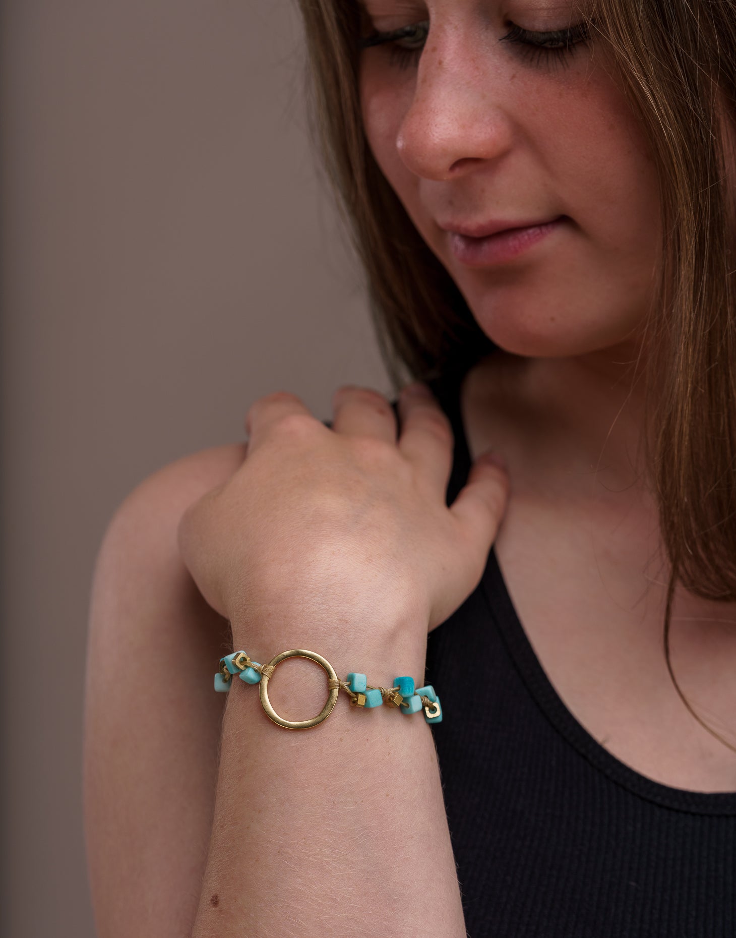 A delicate Dainty Tagua Bracelet featuring mini tagua squares and brass details, elegantly displayed on a soft background.