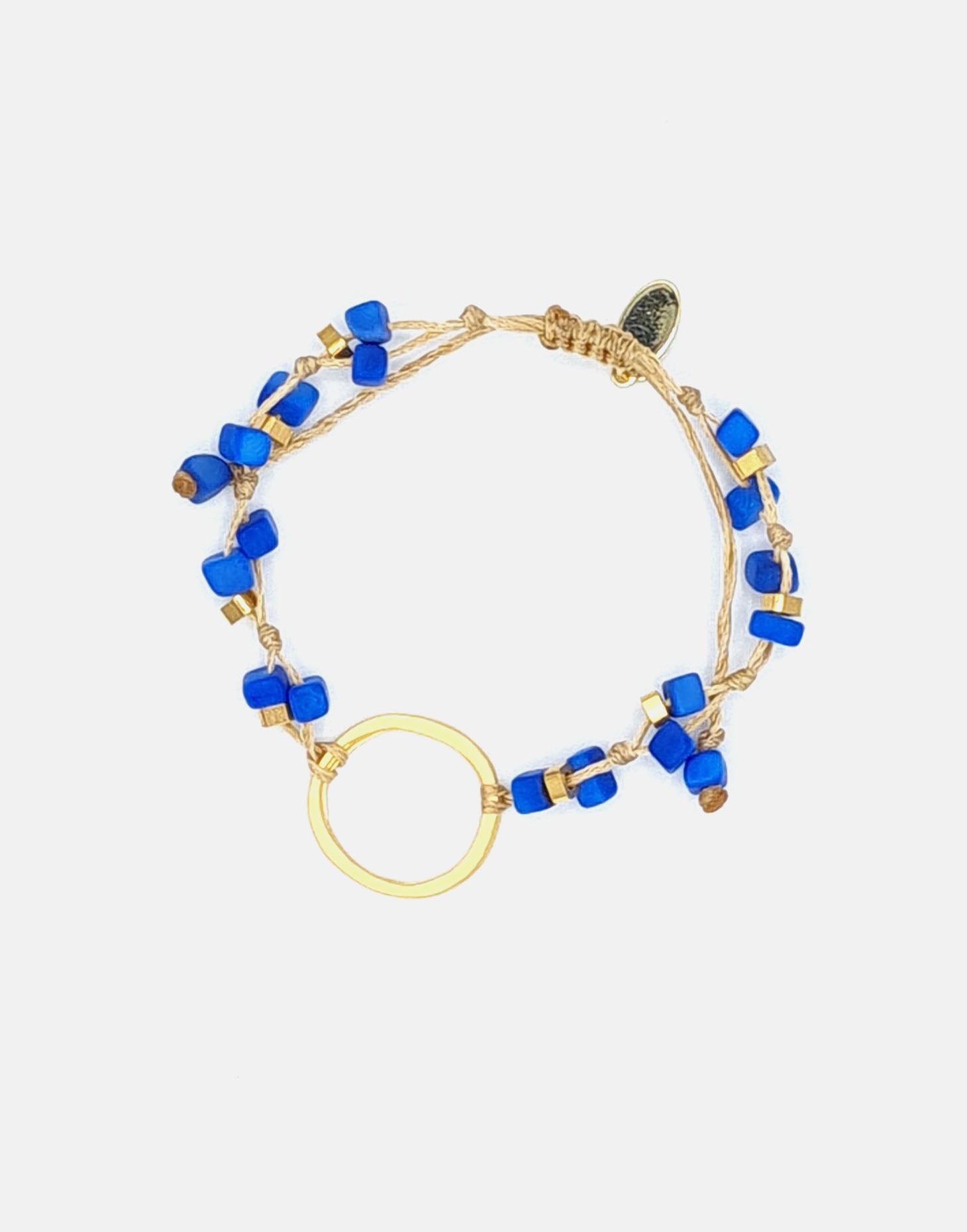 A delicate Dainty Tagua Bracelet featuring mini tagua squares and brass details, elegantly displayed on a soft background.