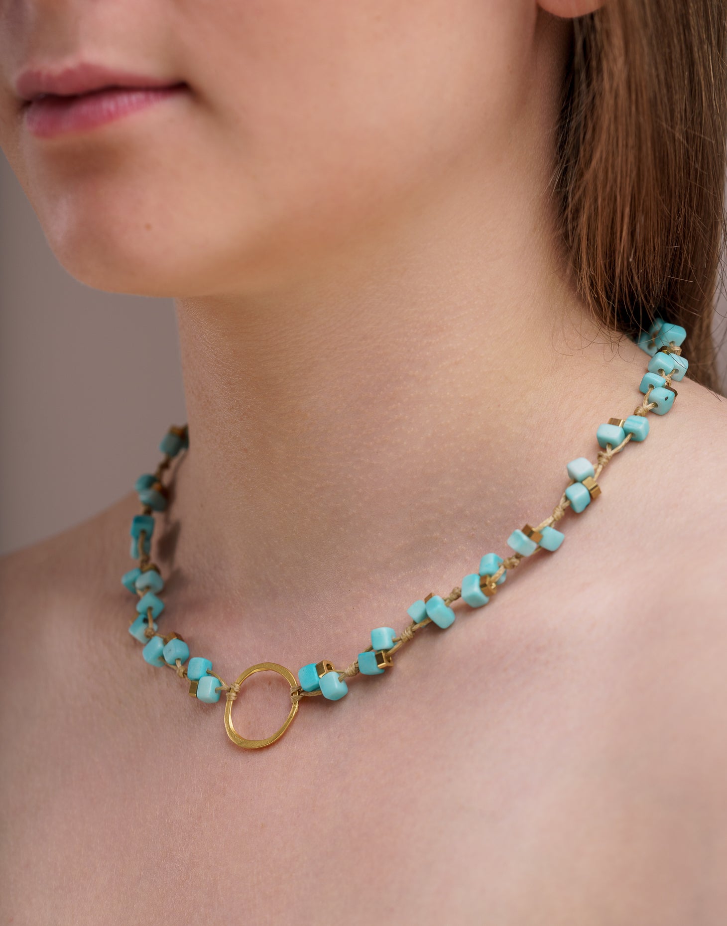 Dainty Tagua Necklace featuring delicate mini tagua squares and brass details, elegantly displayed.