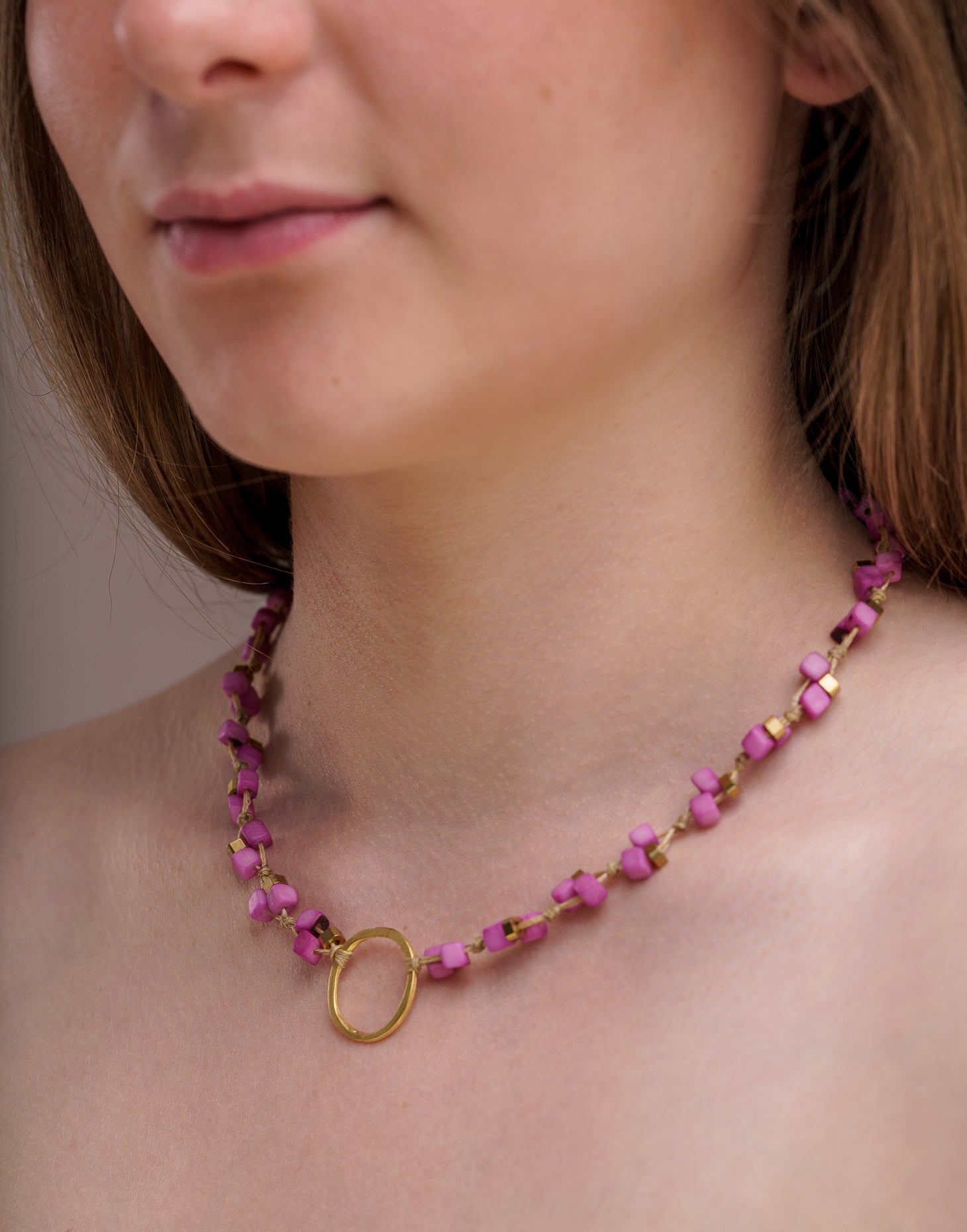 Dainty Tagua Necklace featuring delicate mini tagua squares and brass details, elegantly displayed.