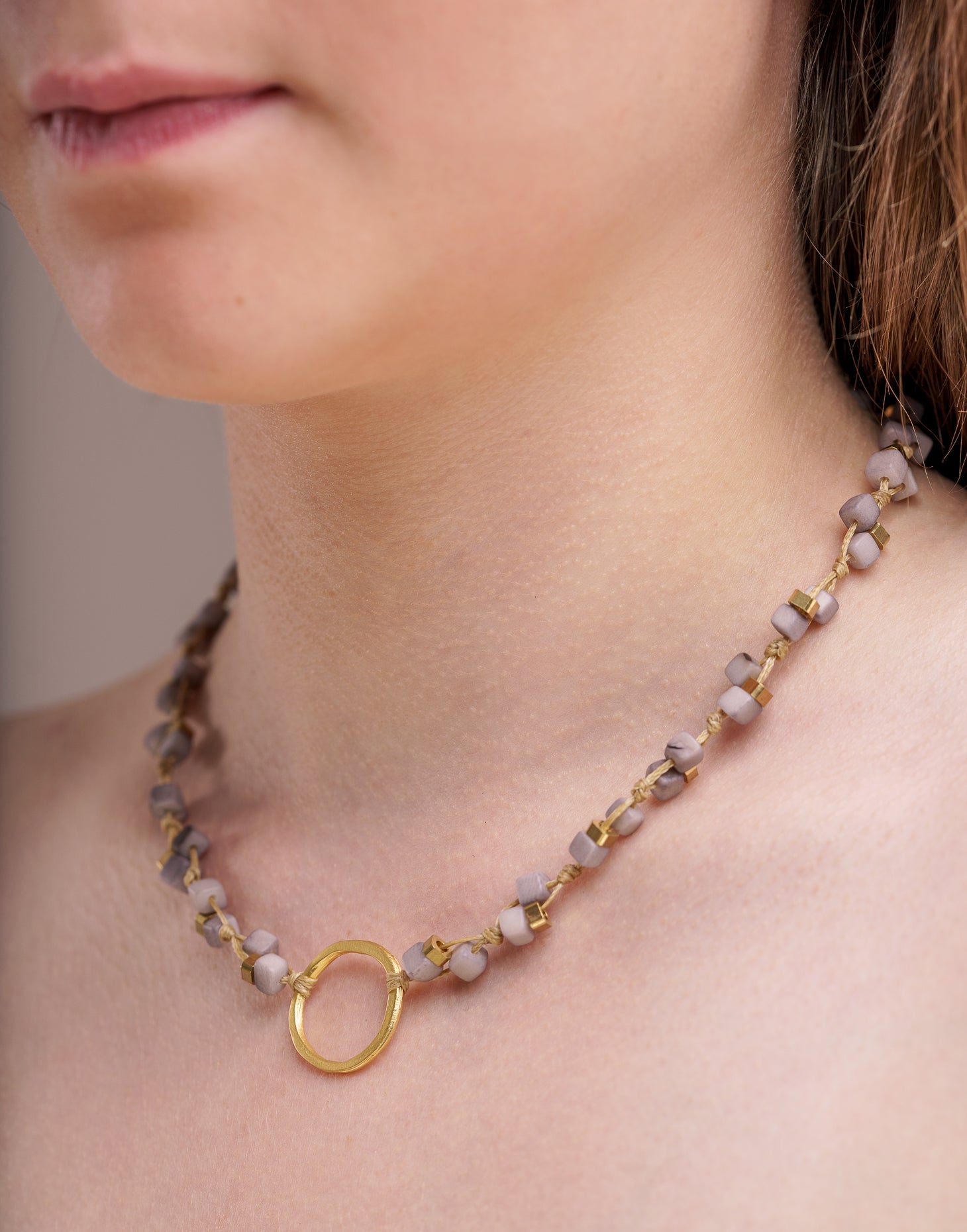 Dainty Tagua Necklace featuring delicate mini tagua squares and brass details, elegantly displayed.