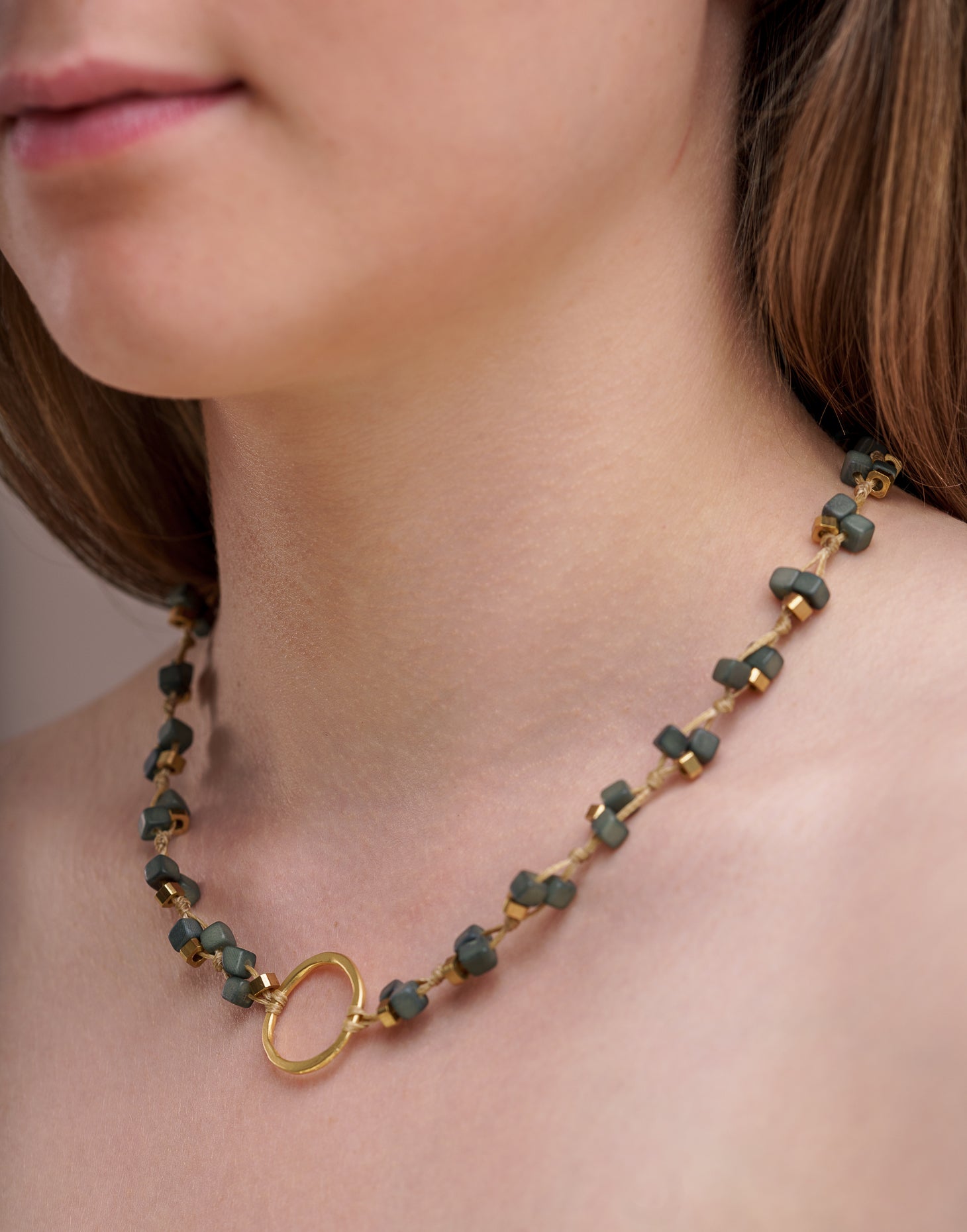 Dainty Tagua Necklace featuring delicate mini tagua squares and brass details, elegantly displayed.