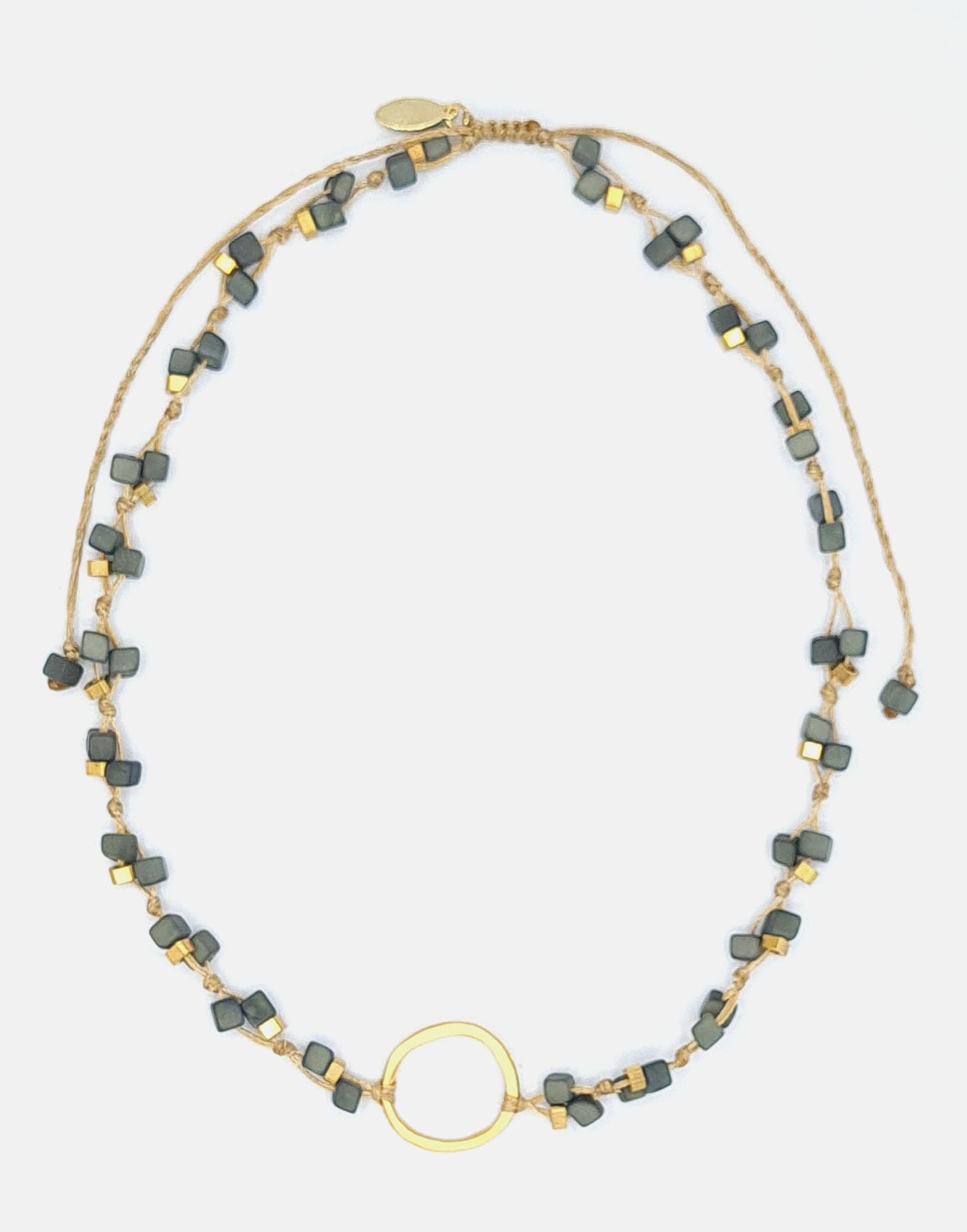 Dainty Tagua Necklace featuring delicate mini tagua squares and brass details, elegantly displayed.