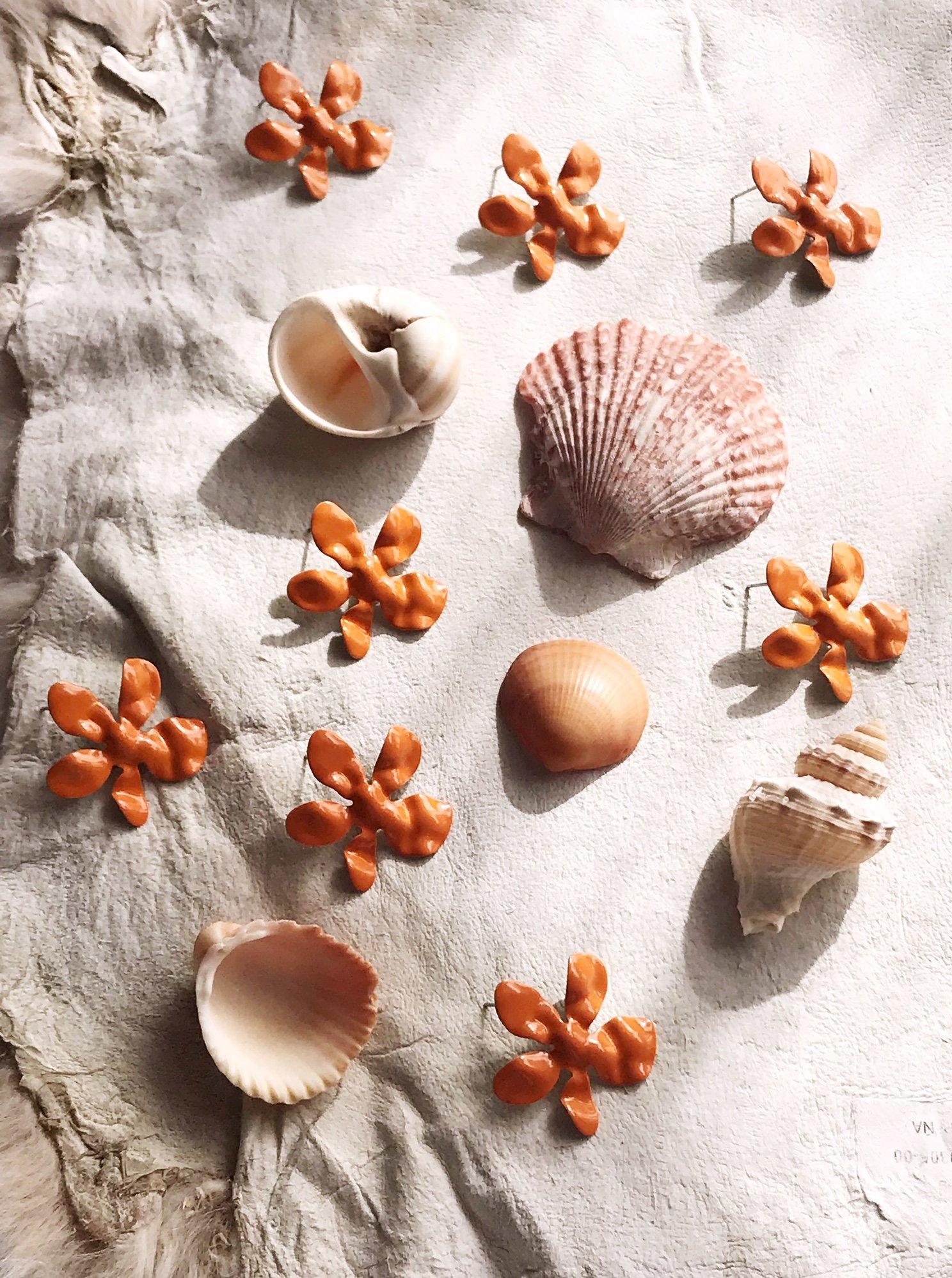 Ivory daisy earrings made of enameled brass with stainless steel ear posts, showcasing a delicate flower design.