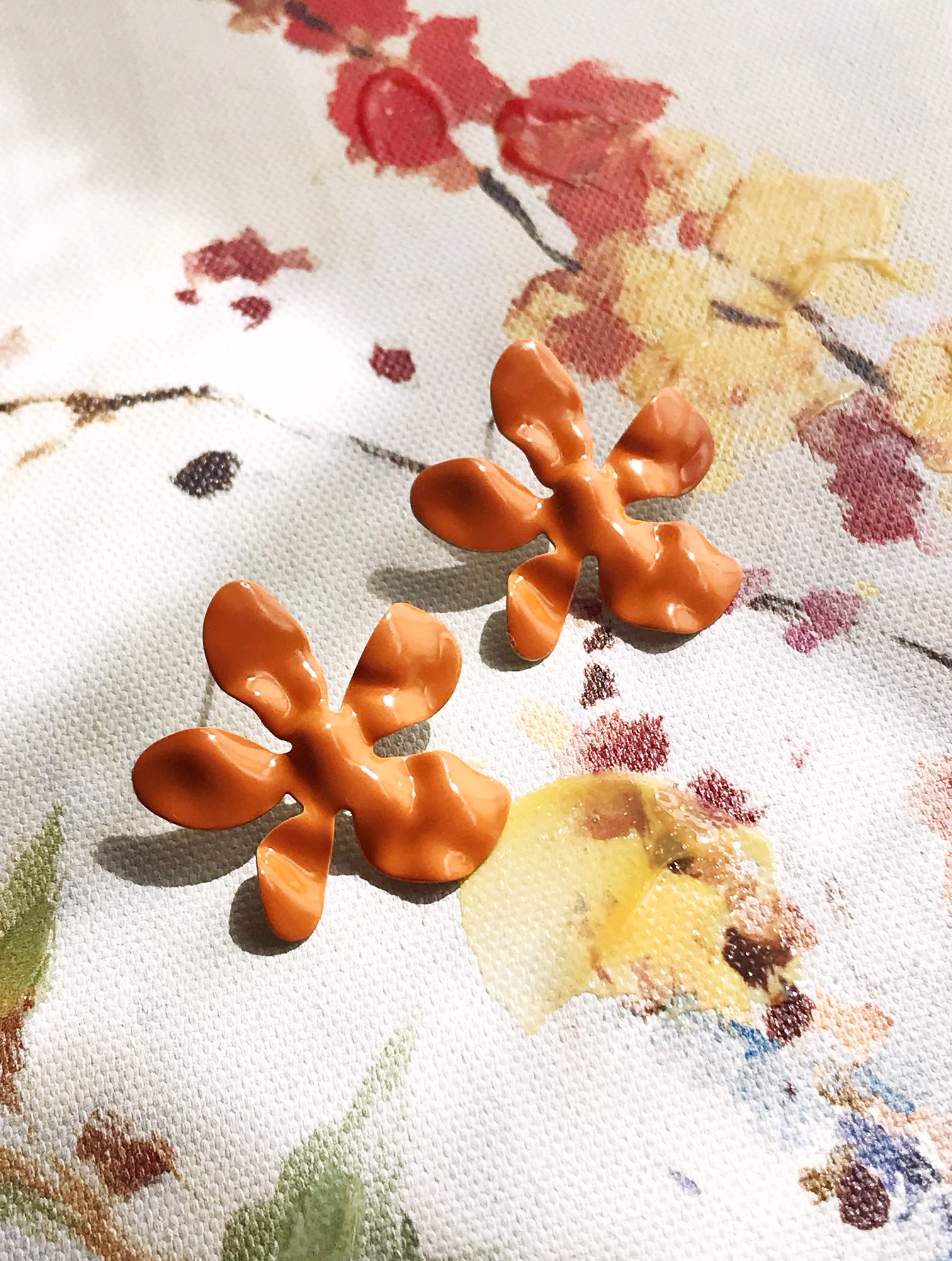 Ivory daisy earrings made of enameled brass with stainless steel ear posts, showcasing a delicate flower design.