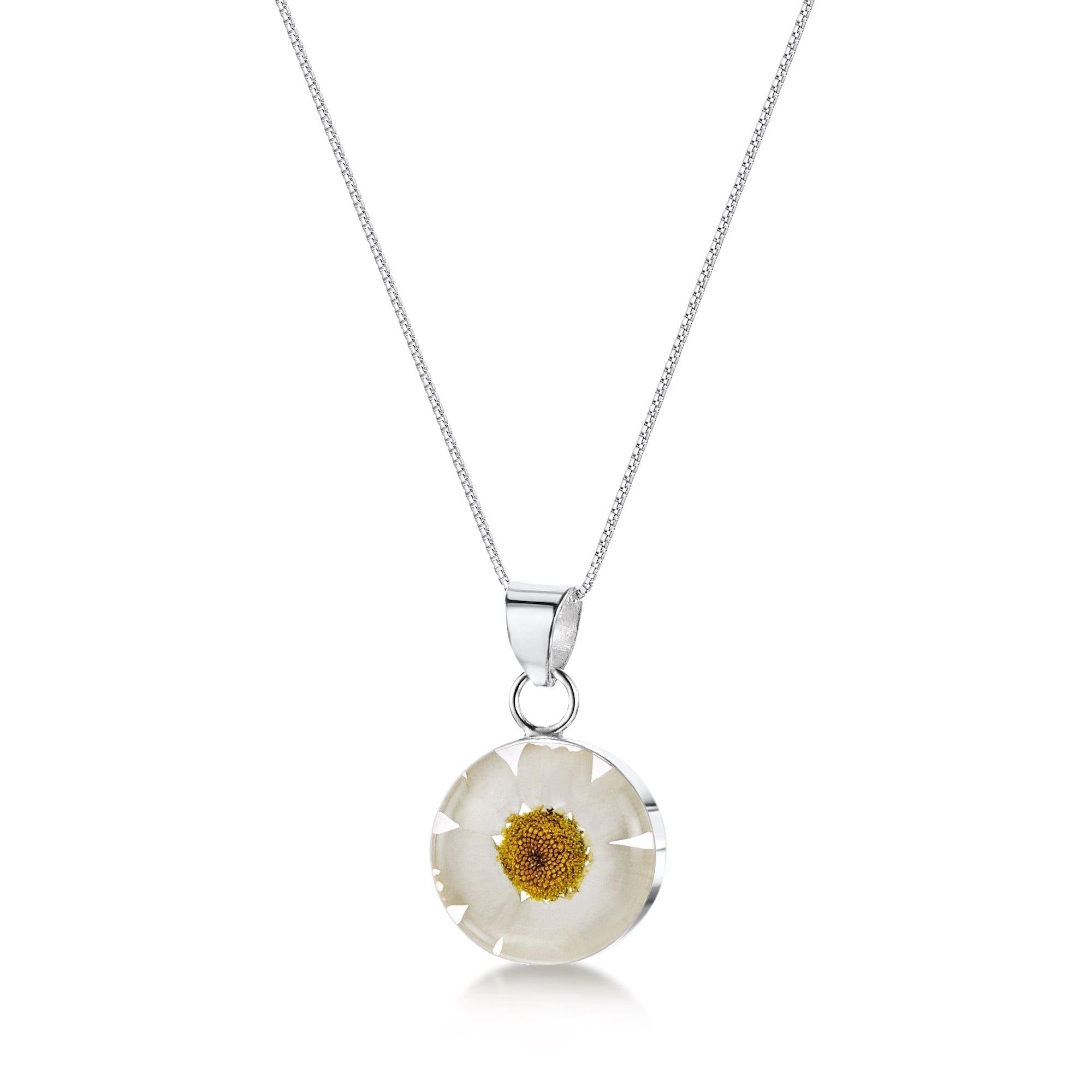 Daisy necklace featuring a real white daisy encased in sterling silver, symbolizing love and purity.