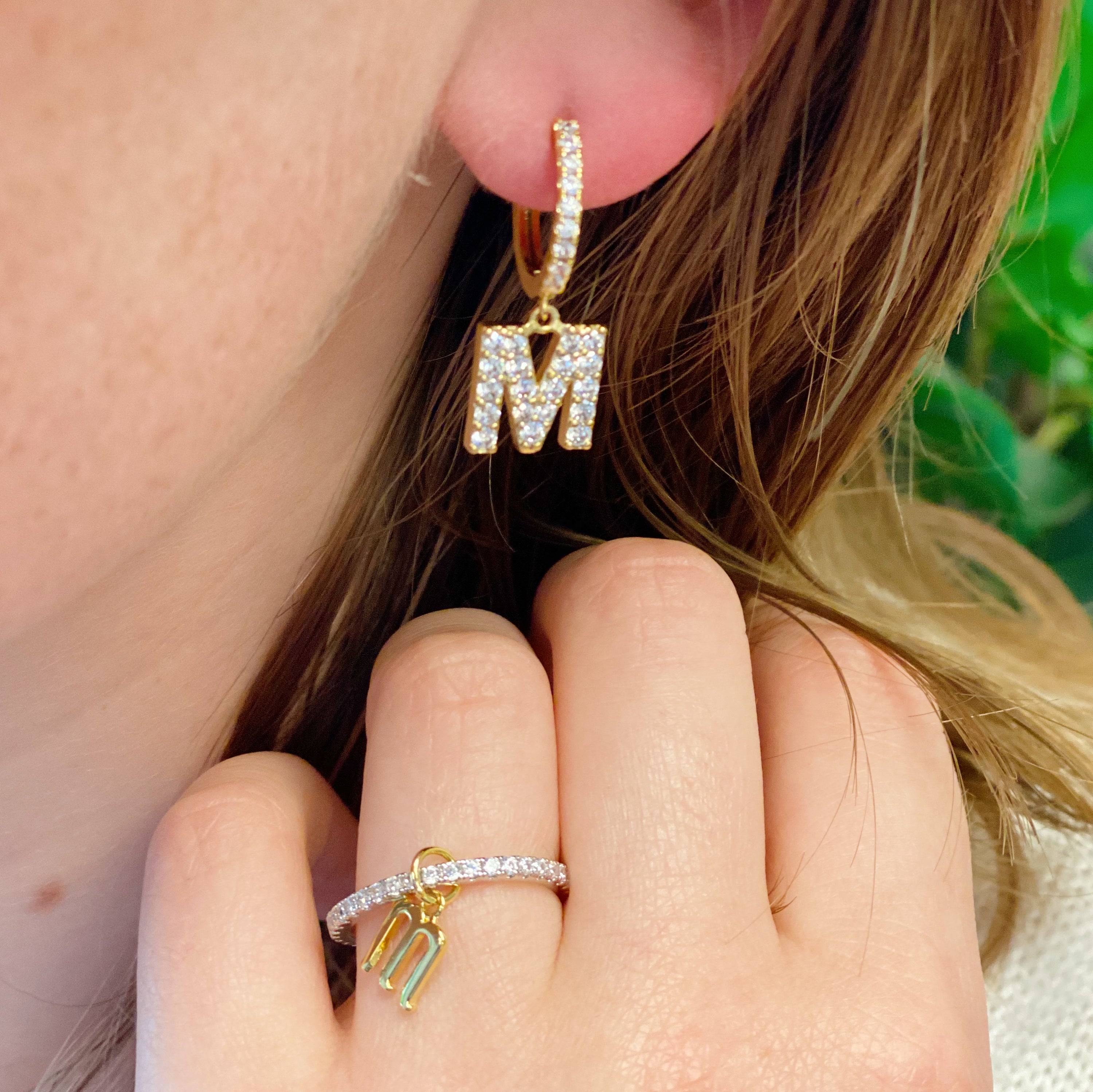 Dangle Initial Ring featuring a gold tone charm and sparkling cubic zirconia accents, elegantly designed for a dainty look.