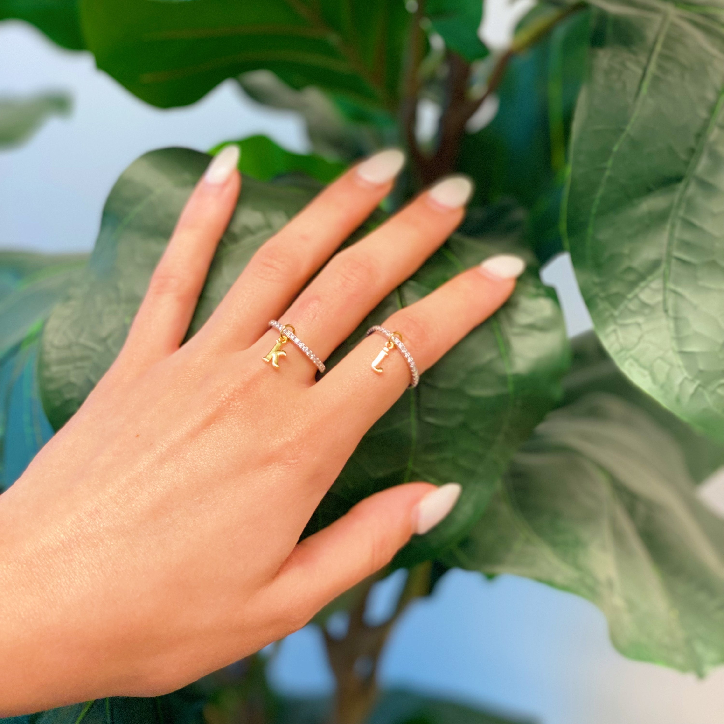 Dangle Initial Ring featuring a gold tone charm and sparkling cubic zirconia accents, elegantly designed for a dainty look.