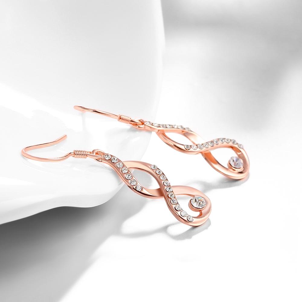 Dangling Infinity Earrings featuring certified crystals and 18K rose gold plating, elegantly designed for comfort and style.