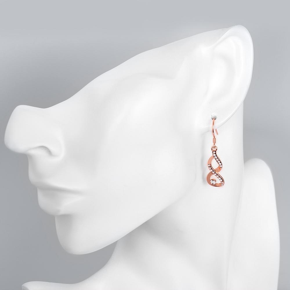 Dangling Infinity Earrings featuring certified crystals and 18K rose gold plating, elegantly designed for comfort and style.