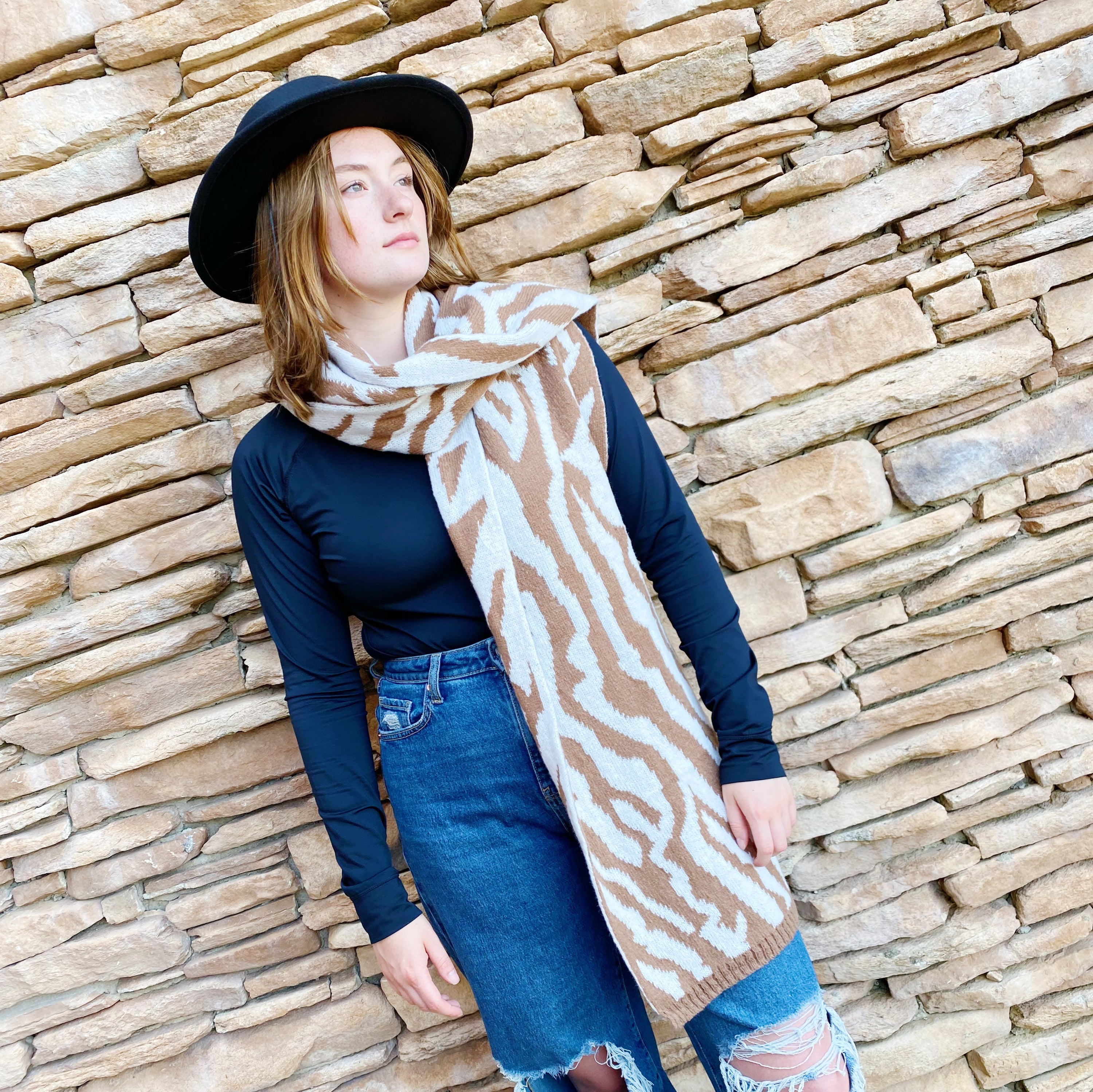 A cozy knit scarf featuring a trendy zebra pattern, reversible for versatile styling, measuring approximately 13 inches by 78 inches.