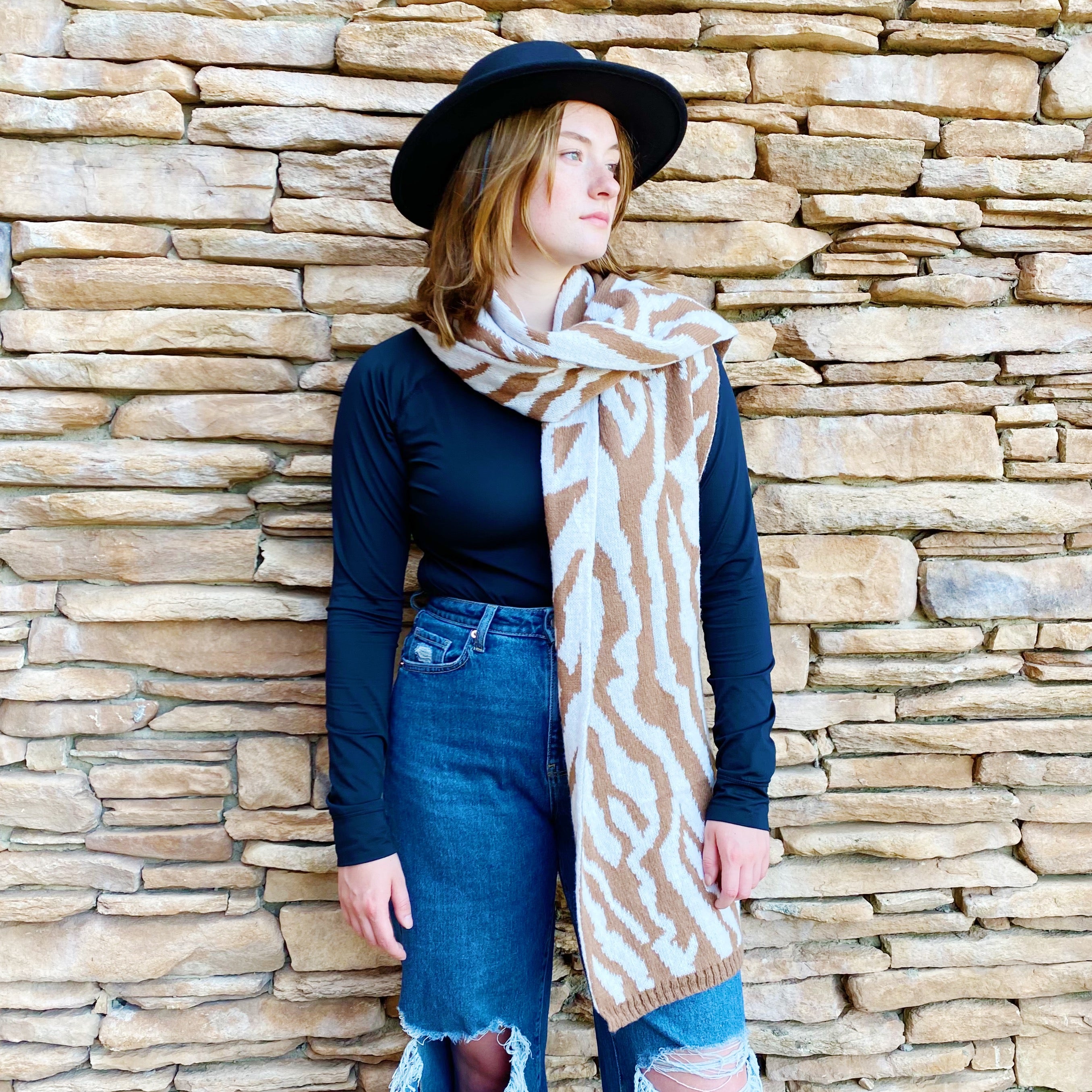 A cozy knit scarf featuring a trendy zebra pattern, reversible for versatile styling, measuring approximately 13 inches by 78 inches.