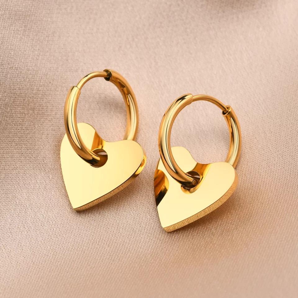 A pair of Dee Heart Earrings featuring a 2-in-1 hoop design with a heart charm, elegantly crafted in 18k gold plated stainless steel.