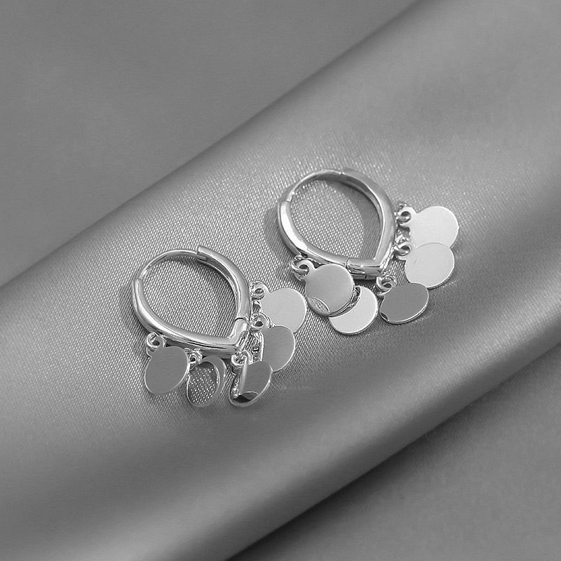 Delicate small hoop earrings featuring round tassels, crafted from lightweight alloy, perfect for stylish everyday wear.