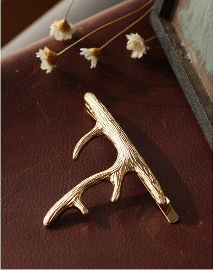 A pair of stylish deer hair clips made from durable alloy, featuring an elegant design suitable for various hairstyles.