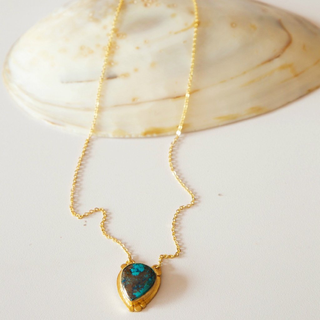 Desert Mother Chrysocolla Necklace featuring a rich chrysocolla stone and scalloped gold plated disc on a thin gold chain.