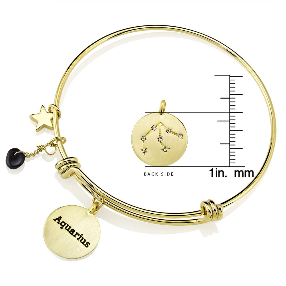 Elegant gold-plated bangle featuring zodiac charms and simulated diamonds, perfect for astrology lovers.