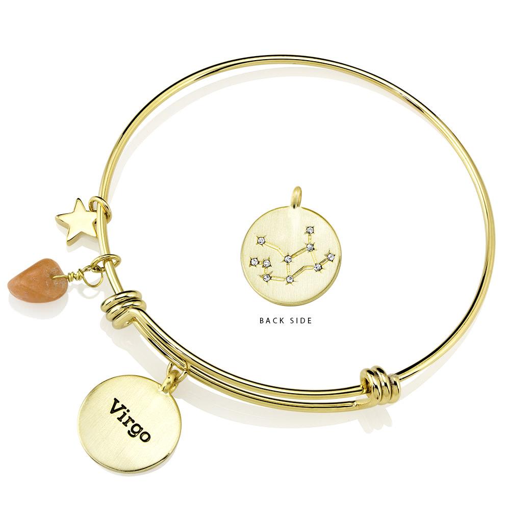 Elegant gold-plated bangle featuring zodiac charms and simulated diamonds, perfect for astrology lovers.