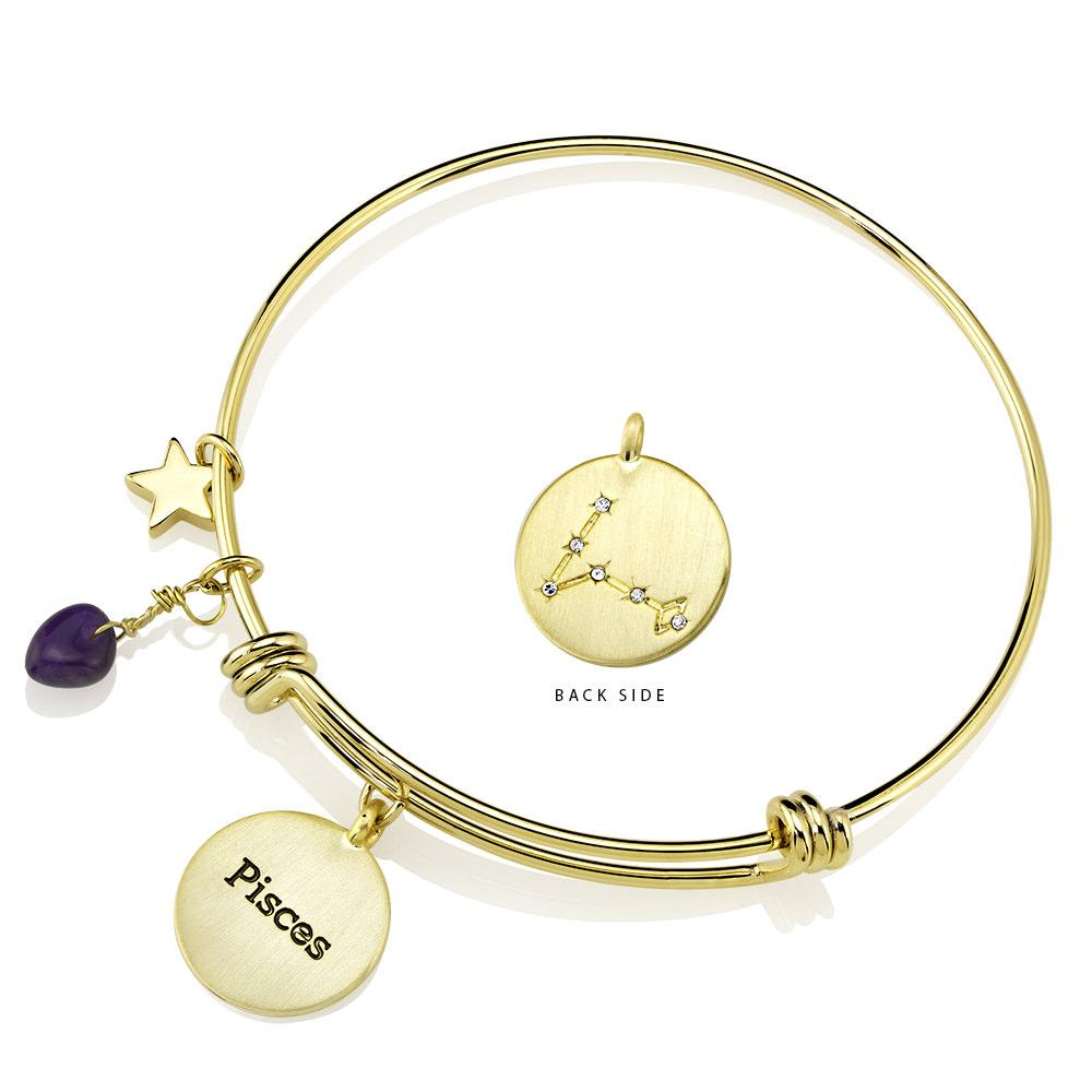 Elegant gold-plated bangle featuring zodiac charms and simulated diamonds, perfect for astrology lovers.