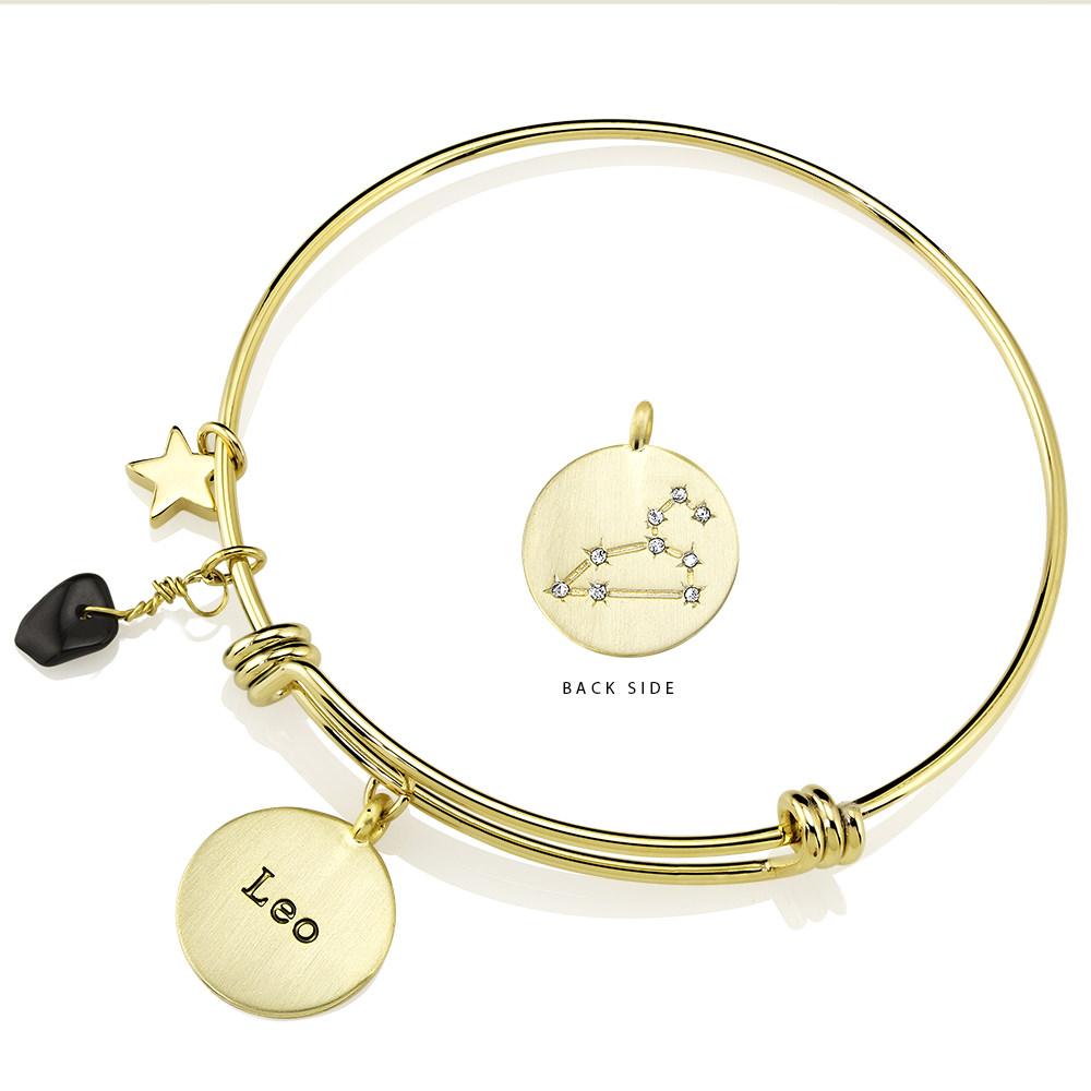 Elegant gold-plated bangle featuring zodiac charms and simulated diamonds, perfect for astrology lovers.